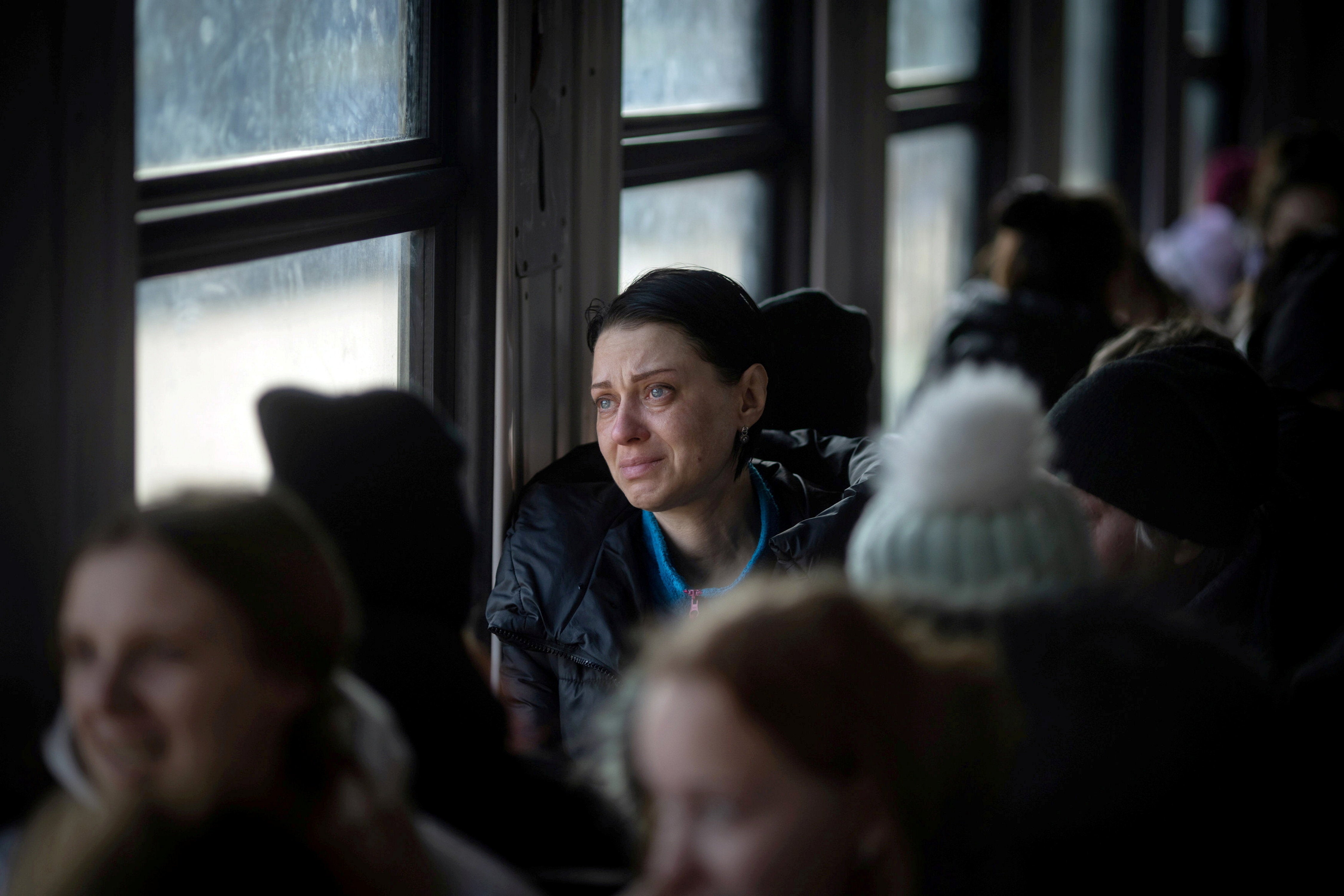 A woman cries as an evacuation train from Lviv, Ukraine, pulls out from the station towards Przemysl, Poland