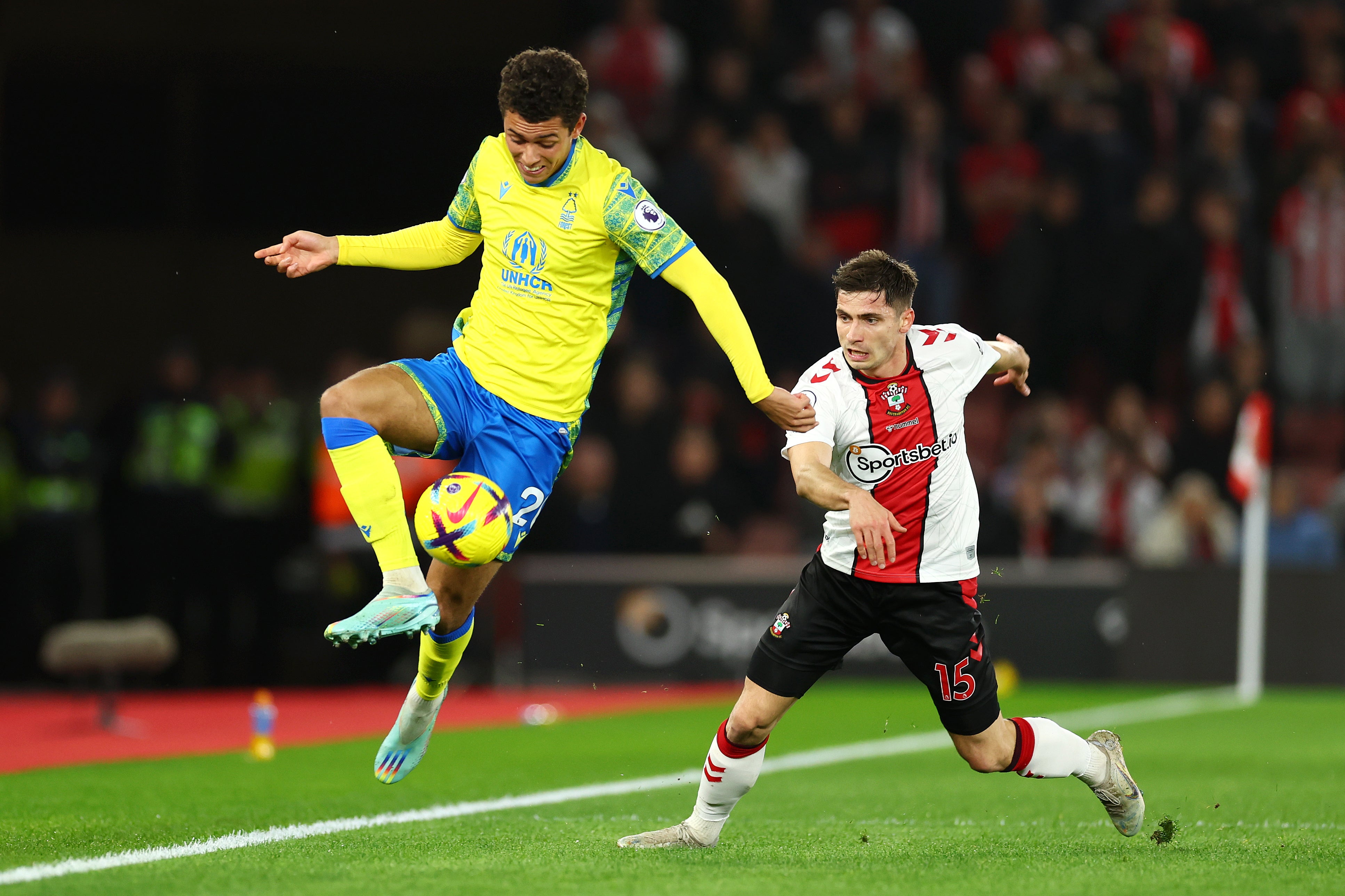 Brennan Johnson of Nottingham Forest battles for possession with Romain Perraud