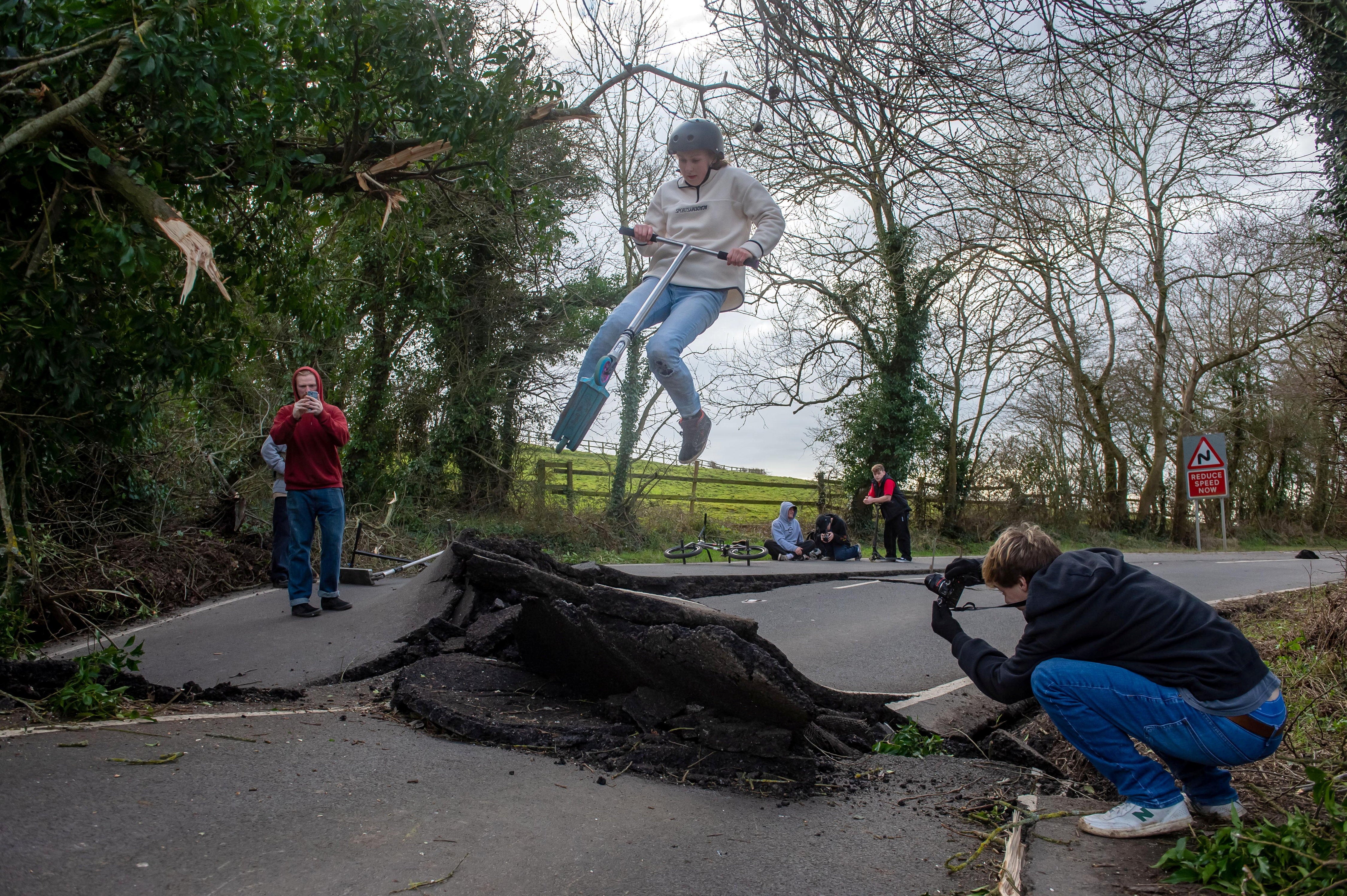 Skateboarders use the landslide-damaged B4069 in Lyneham