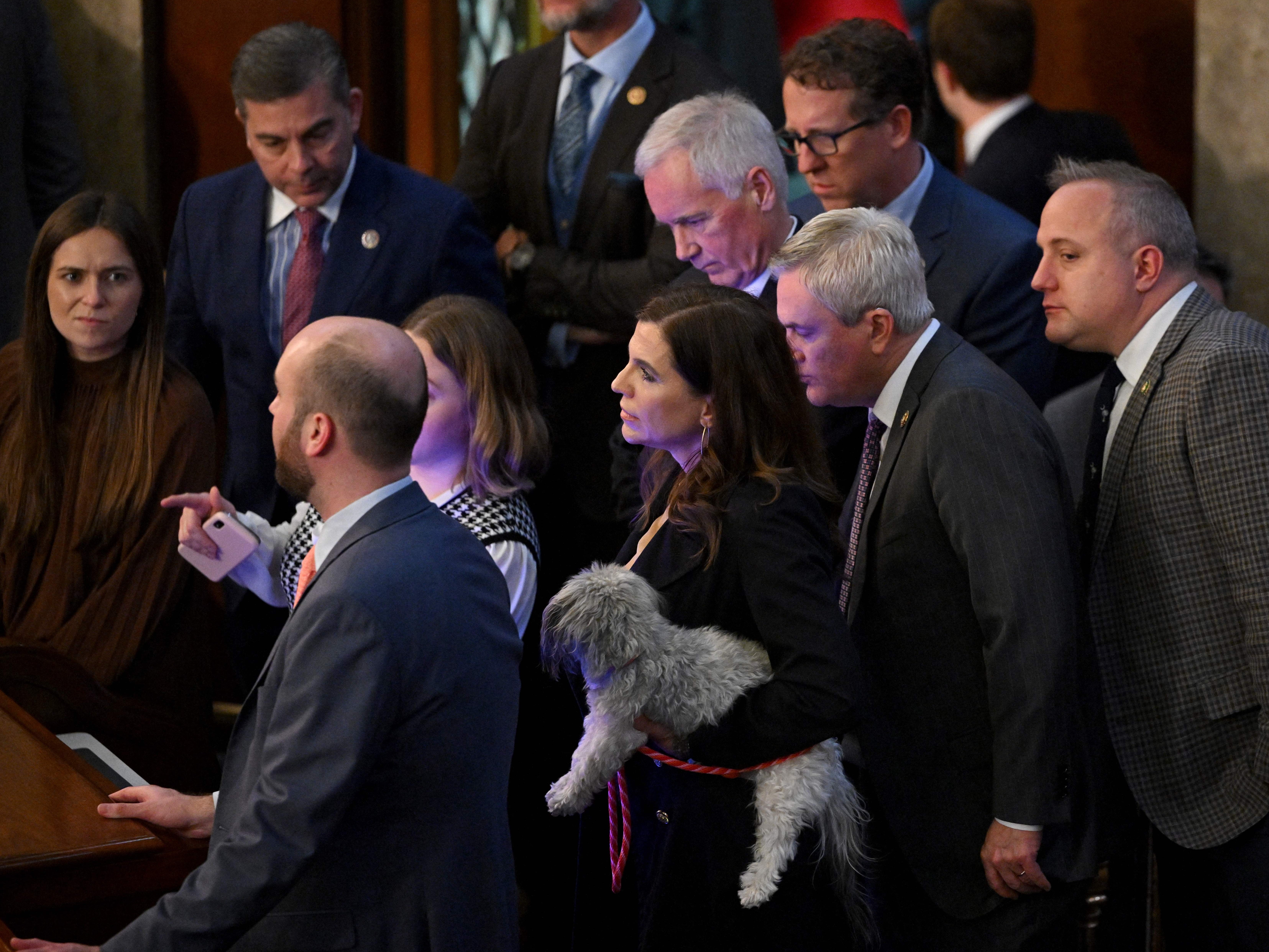 US Representative Nancy Mace carries her dog on the House Floor as voting continues on Thursday