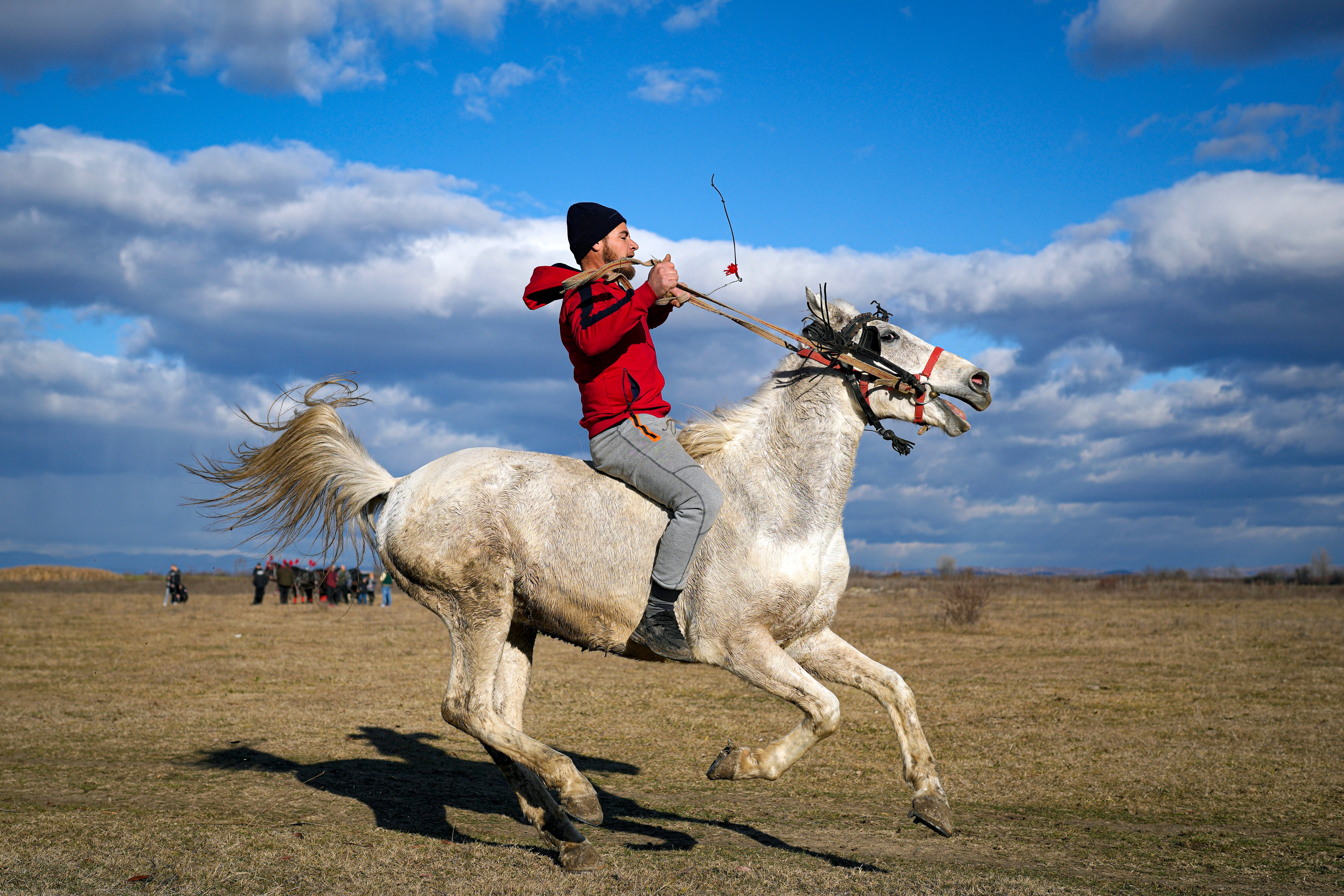 A man rides a horse during Epiphany celebrations in the village of Pietrosani, Romania