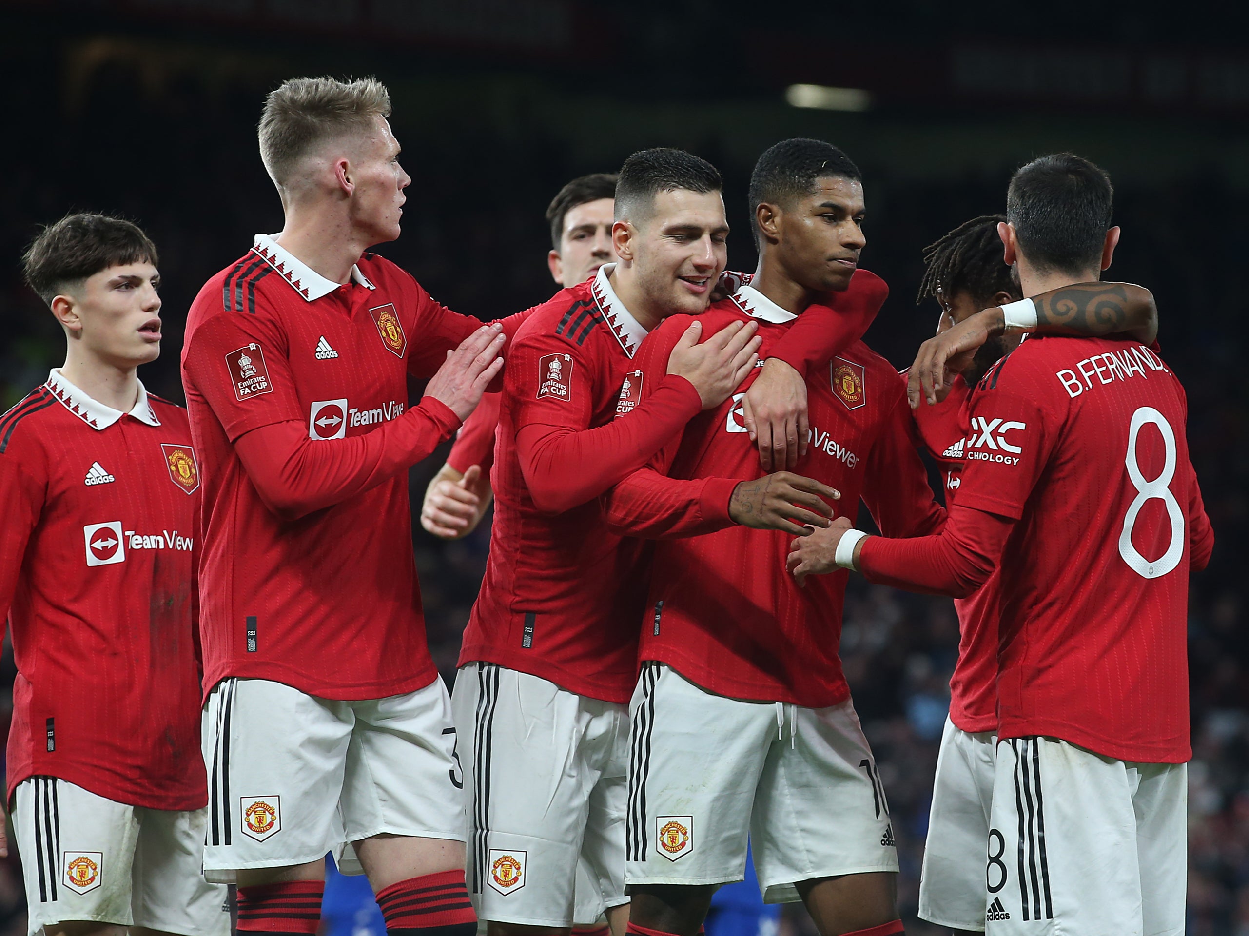 Man Utd players celebrate scoring a third through Marcus Rashford’s penalty