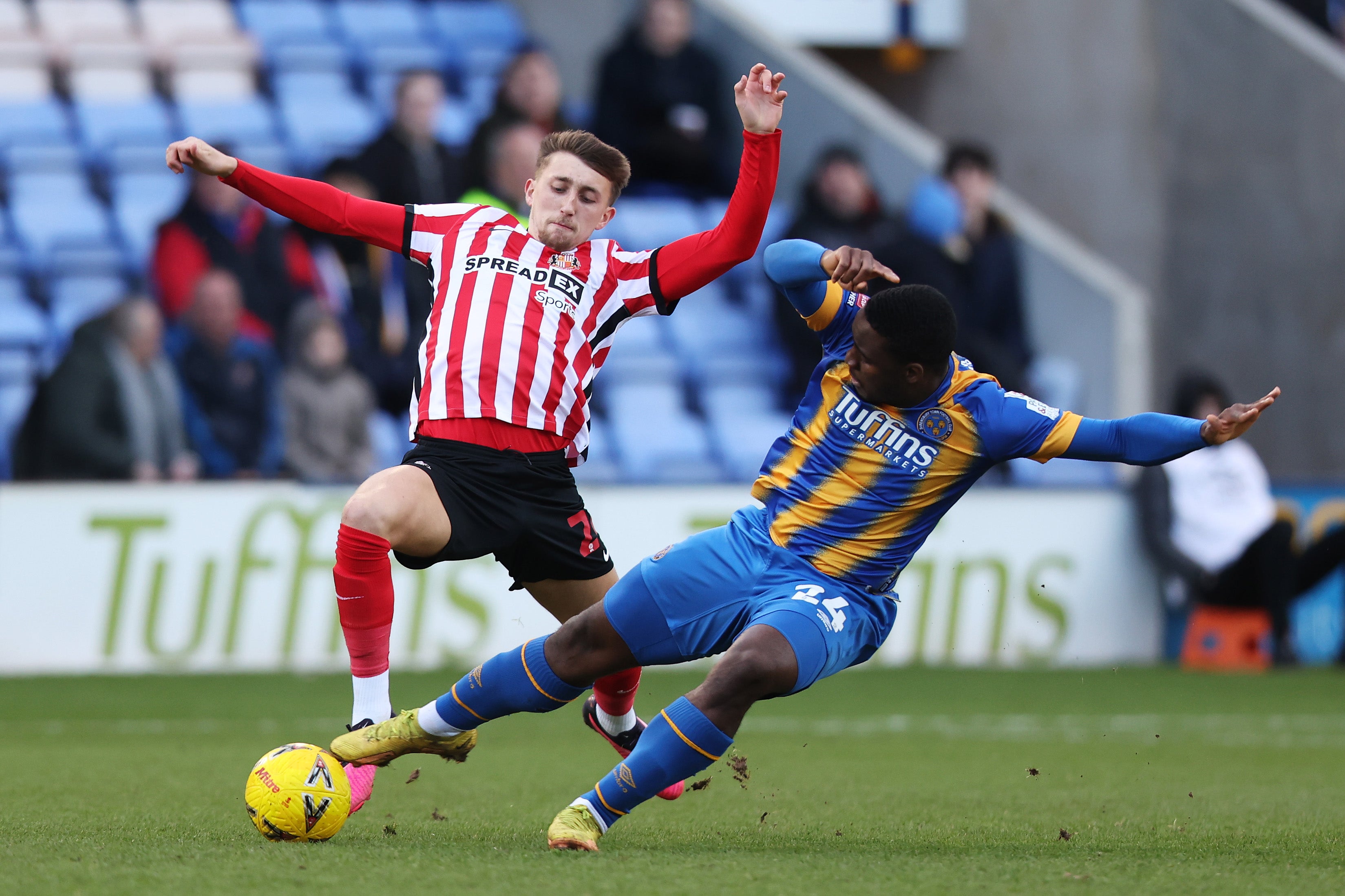 Dan Neil of Sunderland and Christian Saydee of Shrewsbury Town battle for possession