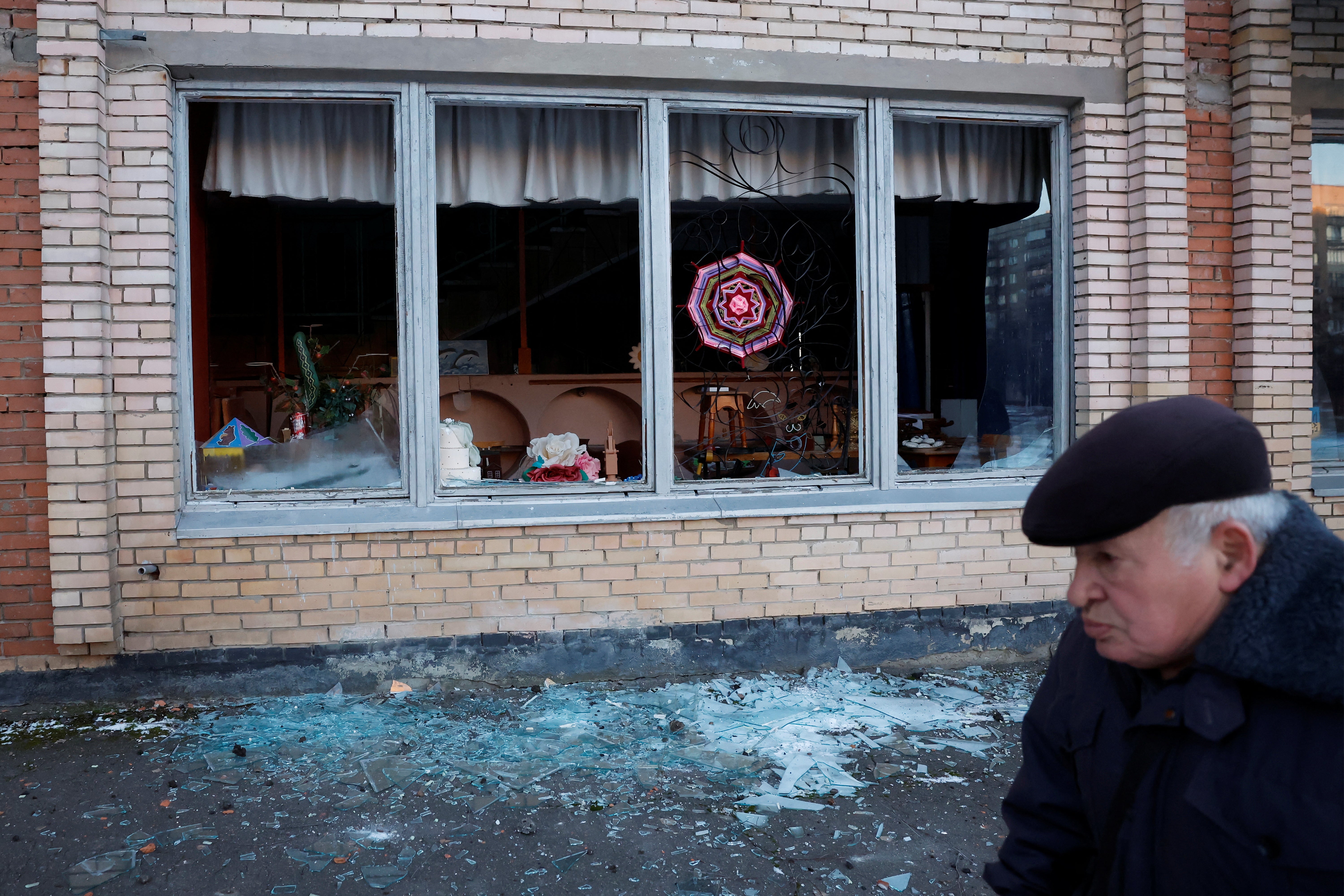 A man walks in front of a damaged building near the site of a missile strike in in Kramatorsk