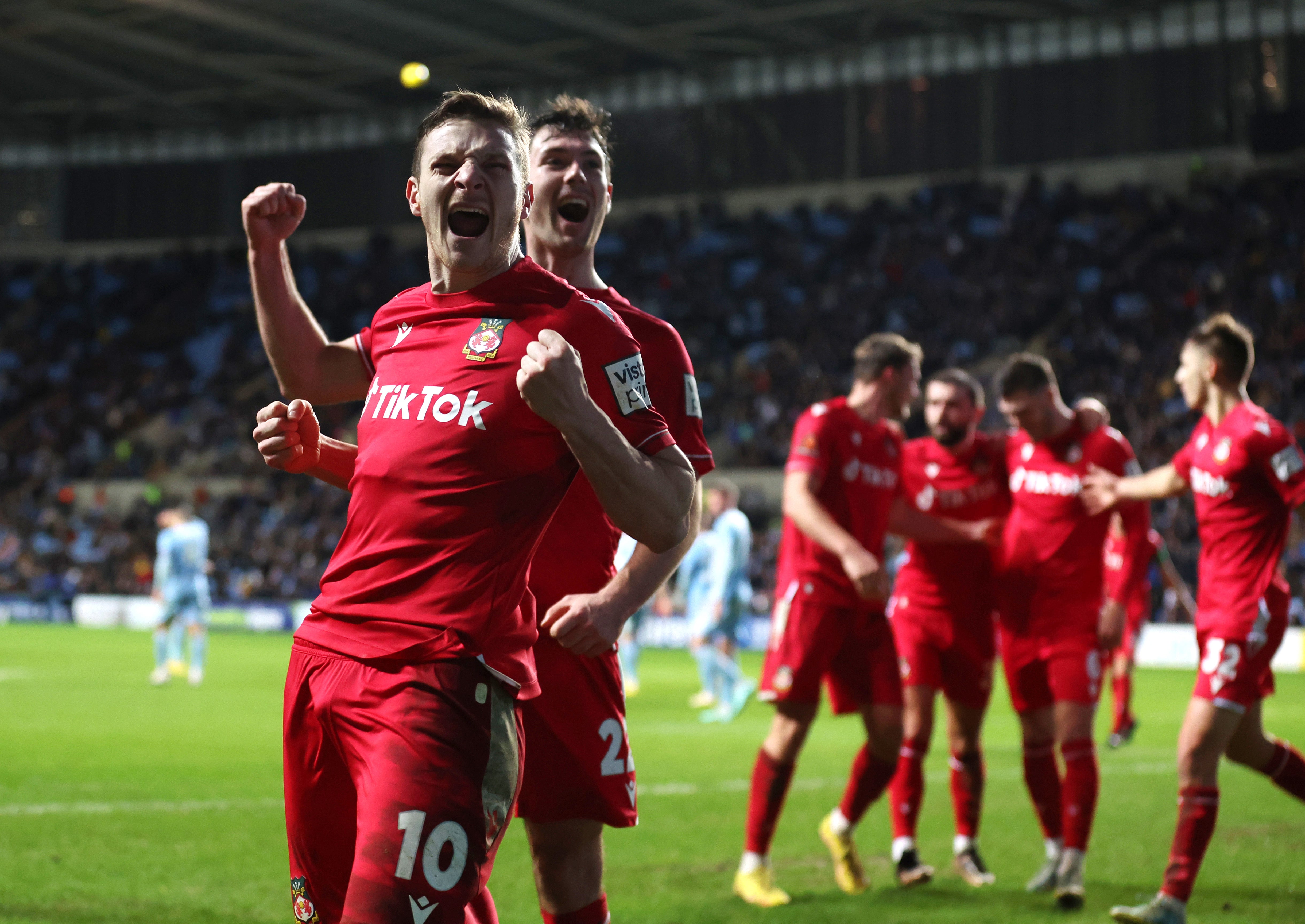 Wrexham celebrate scoring in the FA Cup third round match at Coventry City