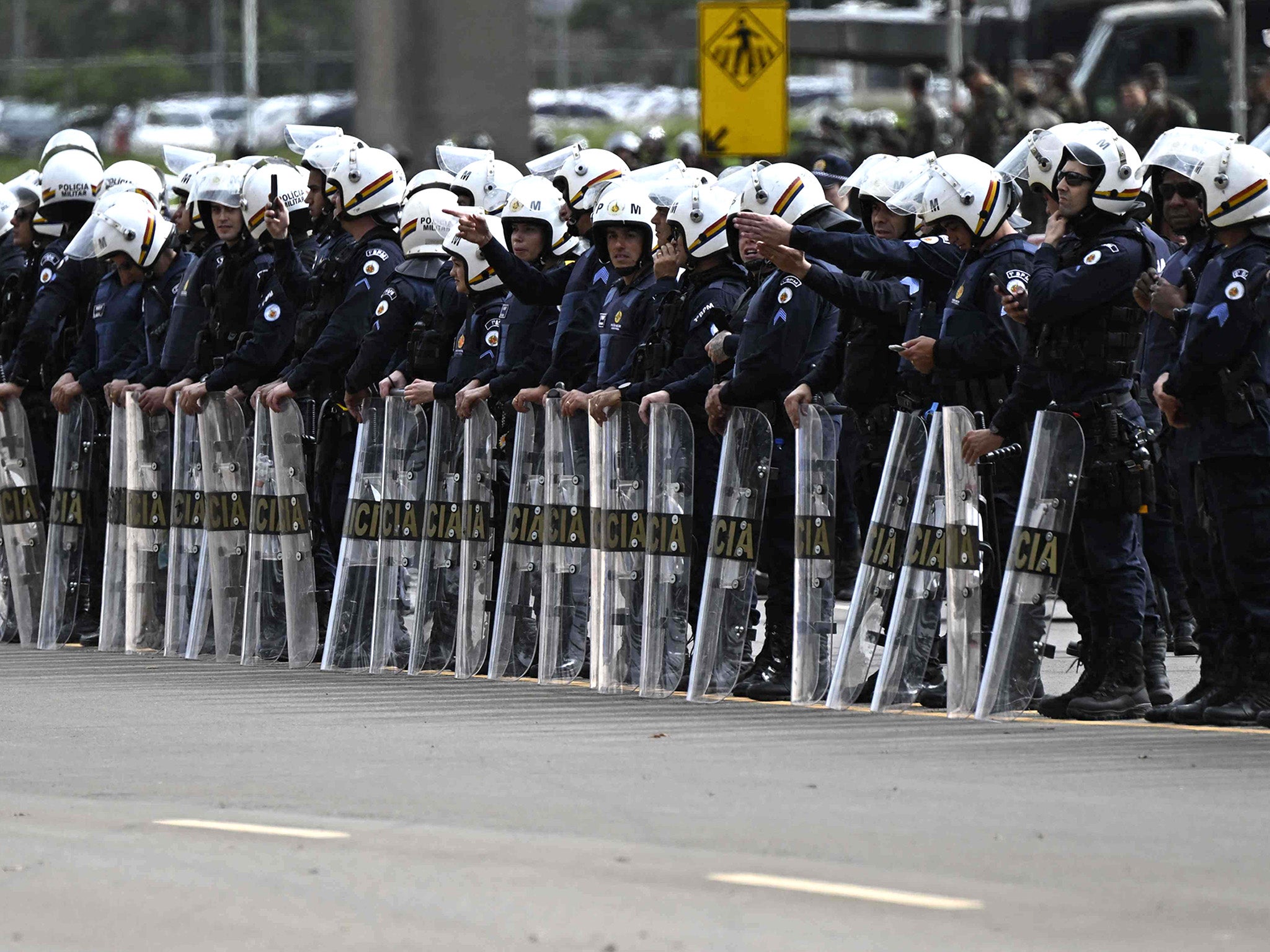 Police forces stand guard as soldiers dismantle a camp by Bolsonaro backers