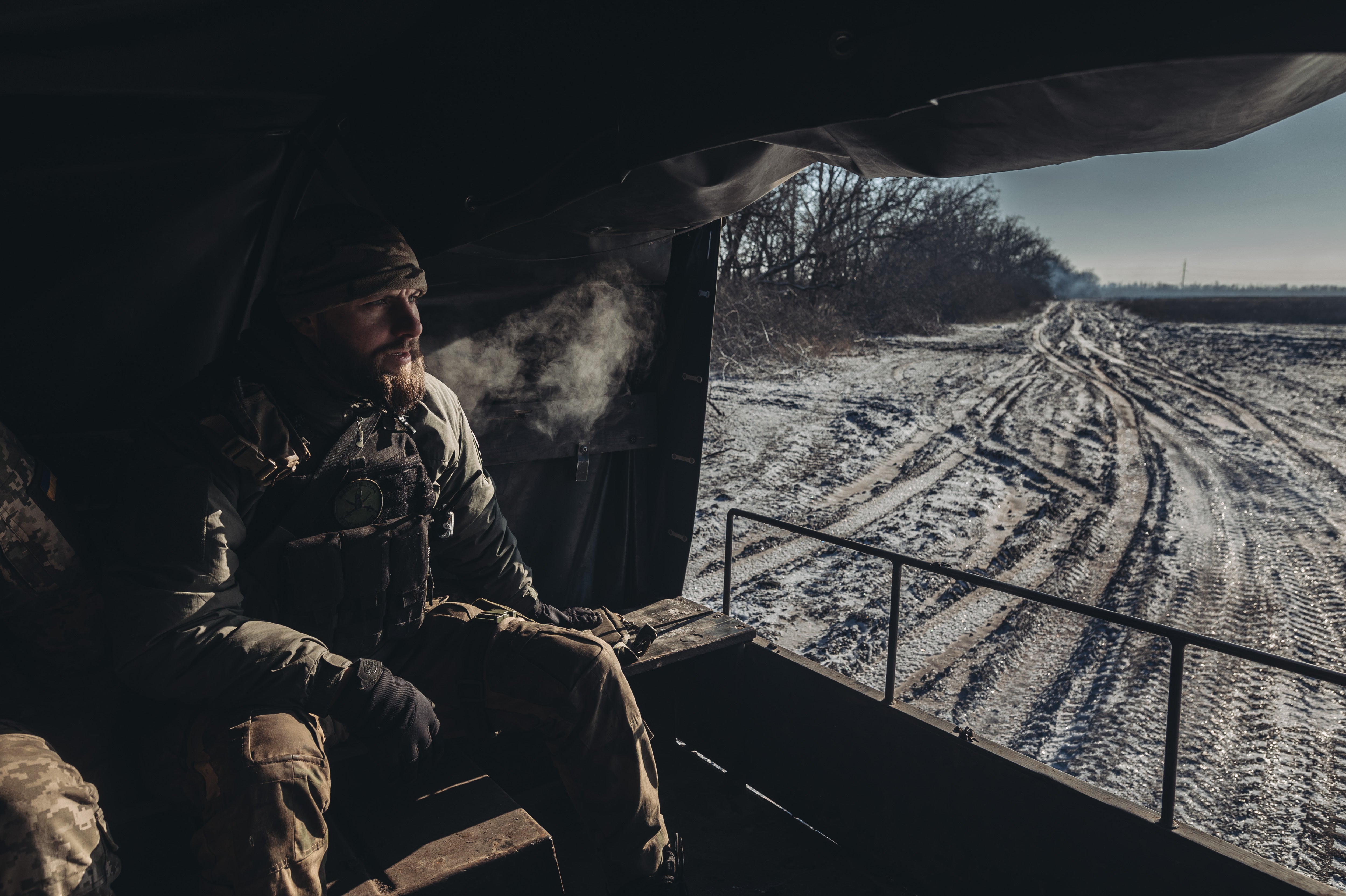 A Ukrainian soldier travelling in a truck on the Bakhmut frontline