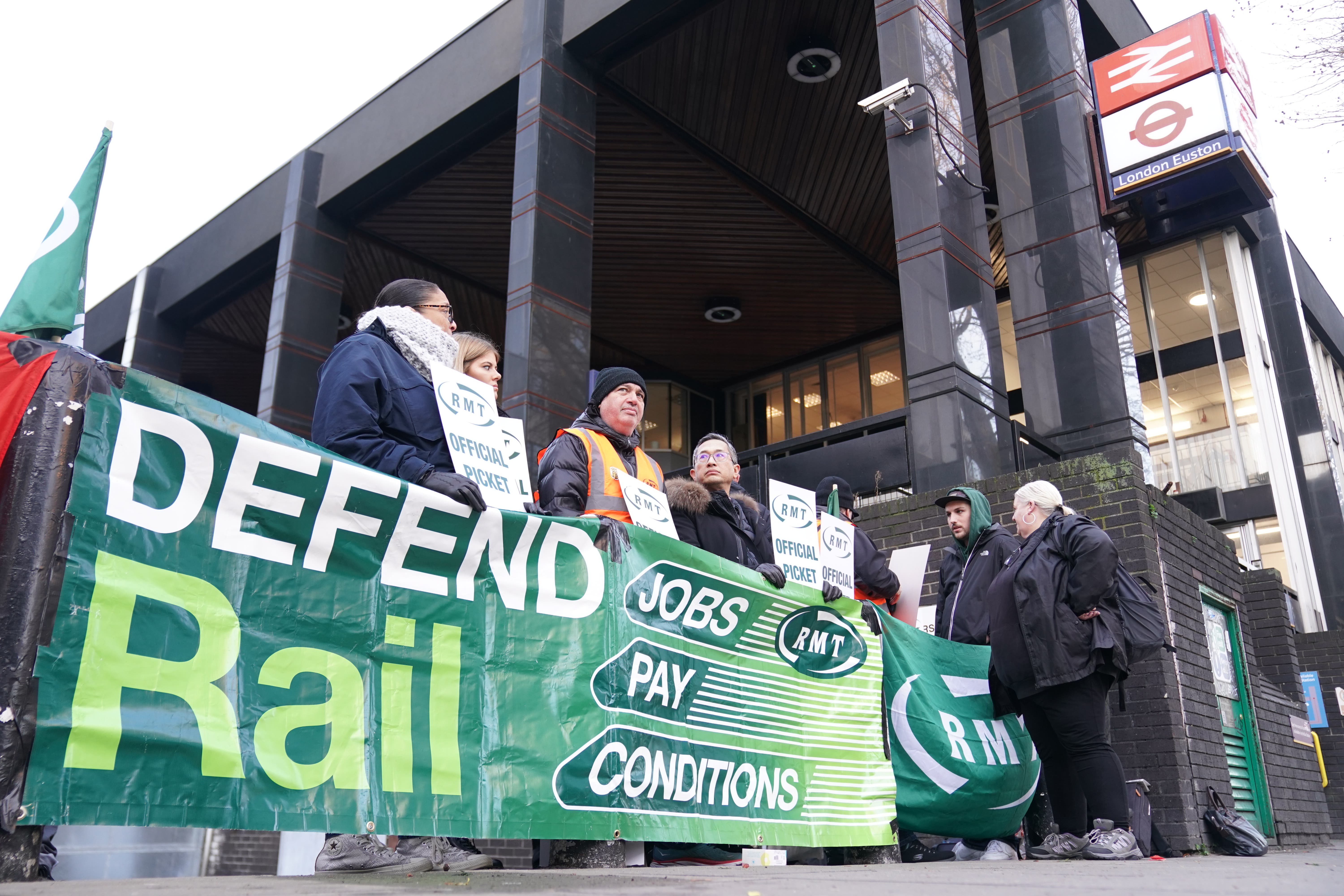 Members of the RMT on the picket line outside Euston station in London (PA)