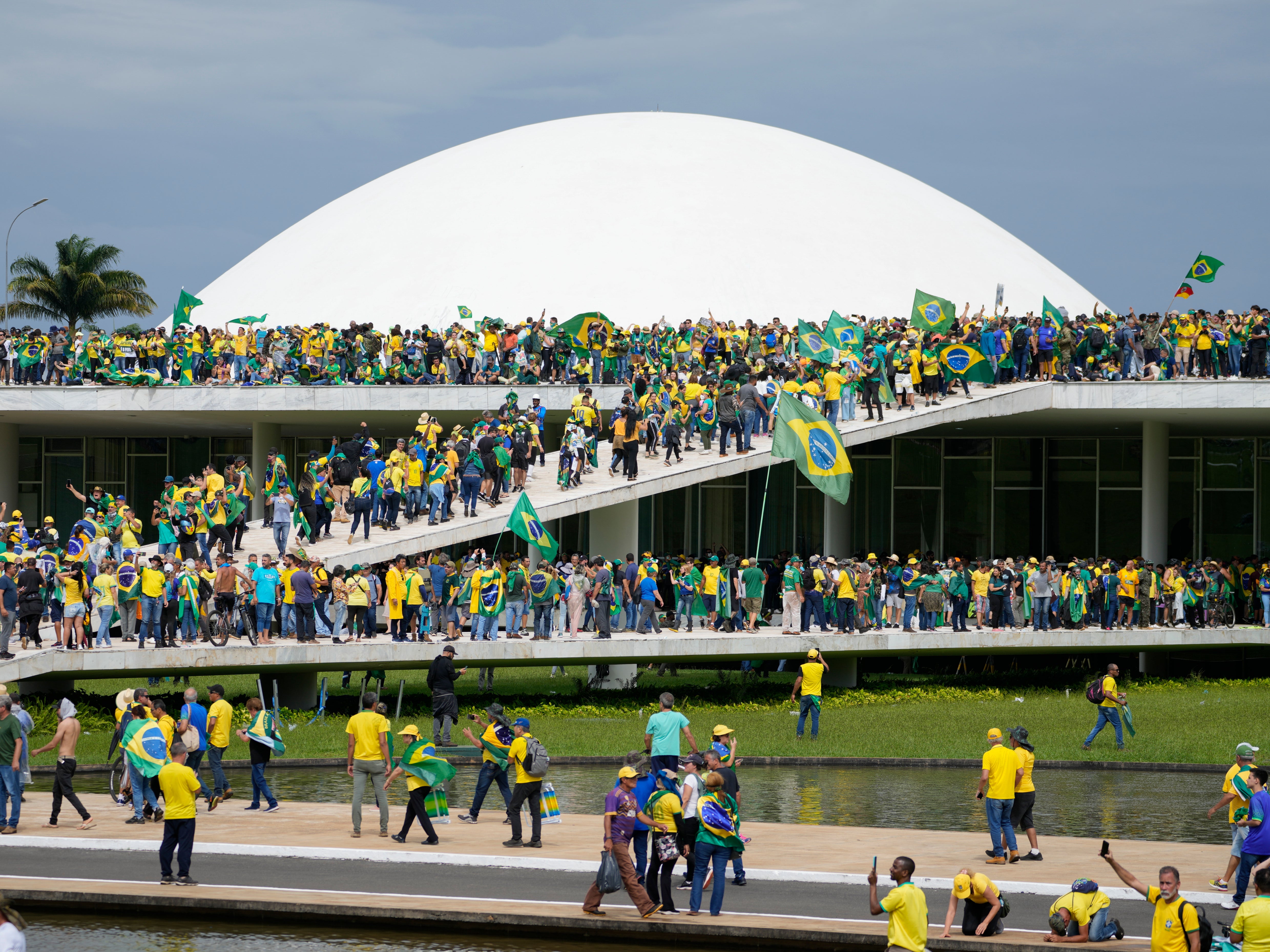 Protesters, supporters of Brazil's former President Jair Bolsonaro, storm the the National Congress building in Brasilia, Brazil, Sunday, Jan. 8, 2023. (AP Photo/Eraldo Peres)