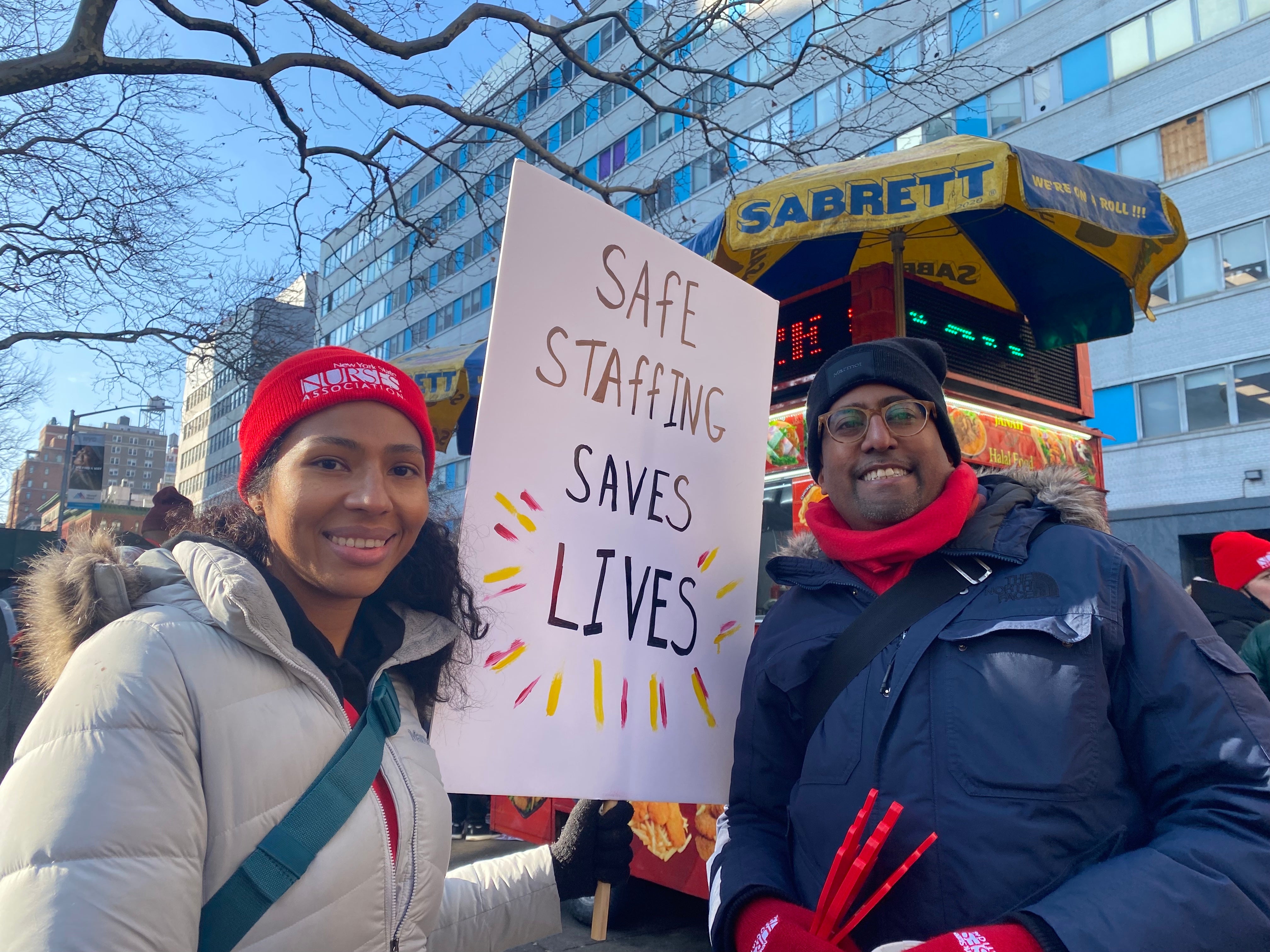 New York nurse Roxanna Garcia, left, and Roy Permaul join hundreds of striking healthcare workers outside Mount Sinai on 9 January.