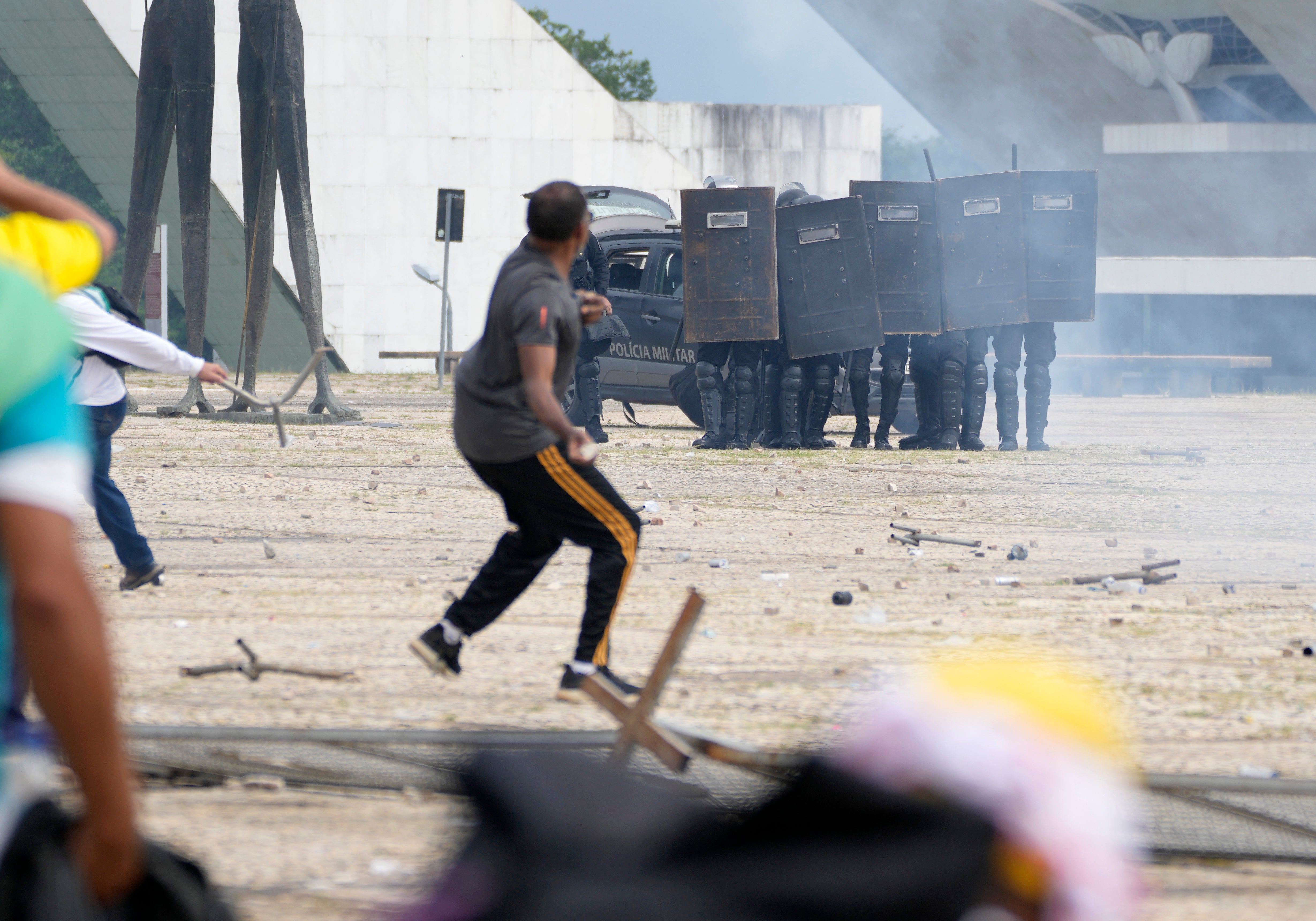 Supporters of Brazil's former president Jair Bolsonaro clash with police as they storms the Planalto Palace in Brasilia