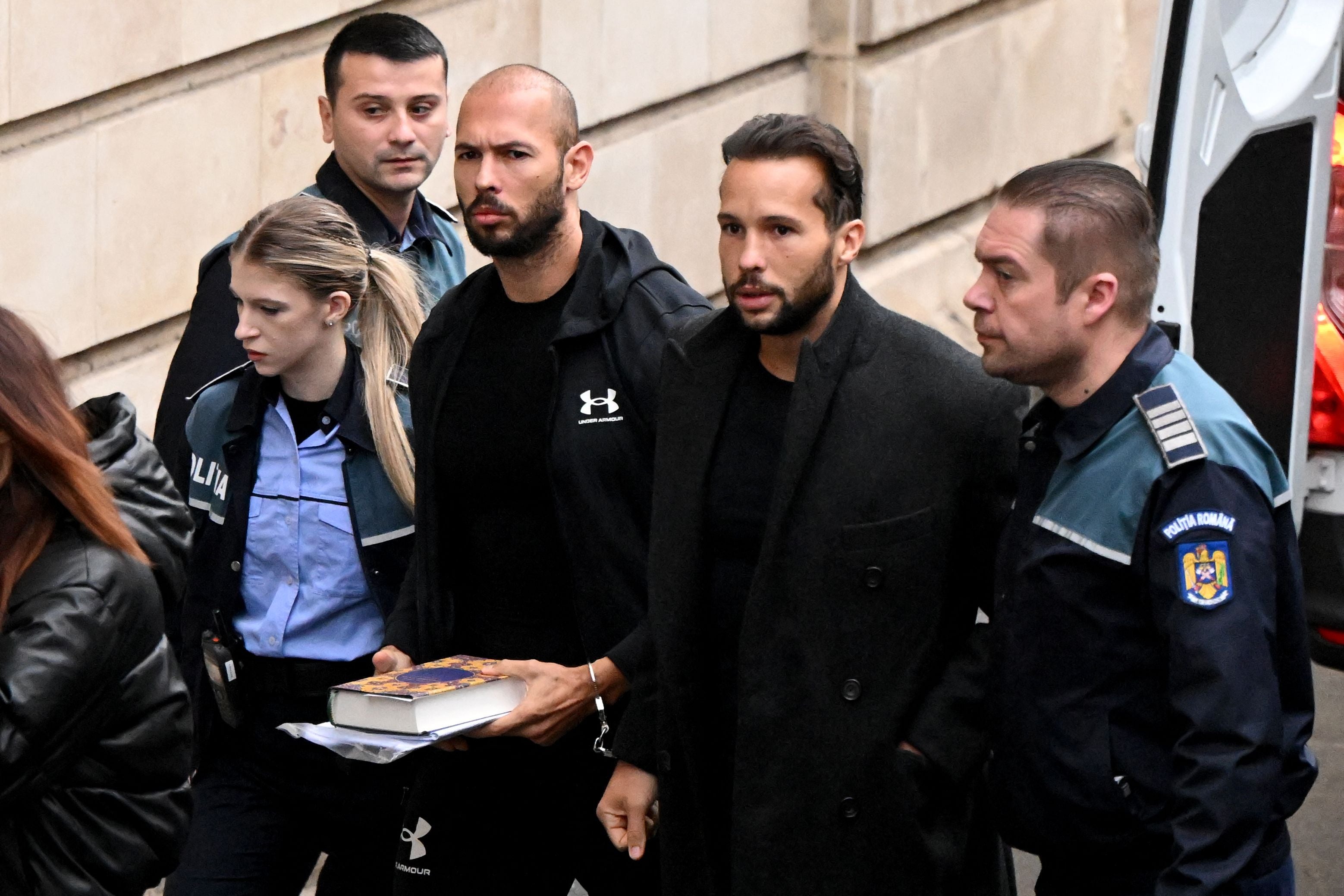 Andrew Tate, 3rd right, and his brother Tristan Tate, 2nd right, arrive at court