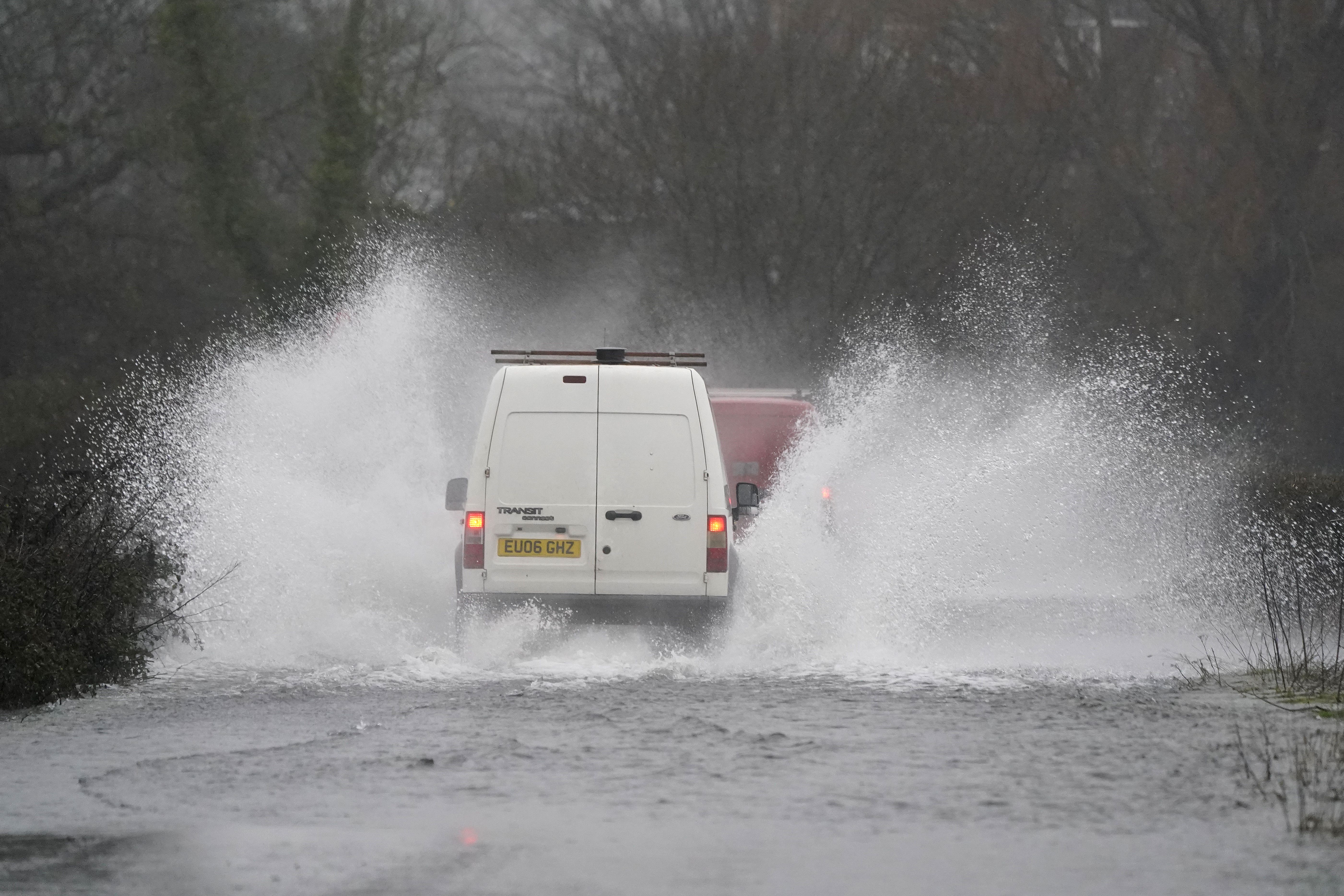 Cars make their way through flood water on Kent Lane, near to Ibsley in Hampshire. The Met Office has issued warnings for heavy rains and floods, falling heaviest in western areas but causing wet and windy conditions all over the country. Picture date: Tuesday January 10, 2023.