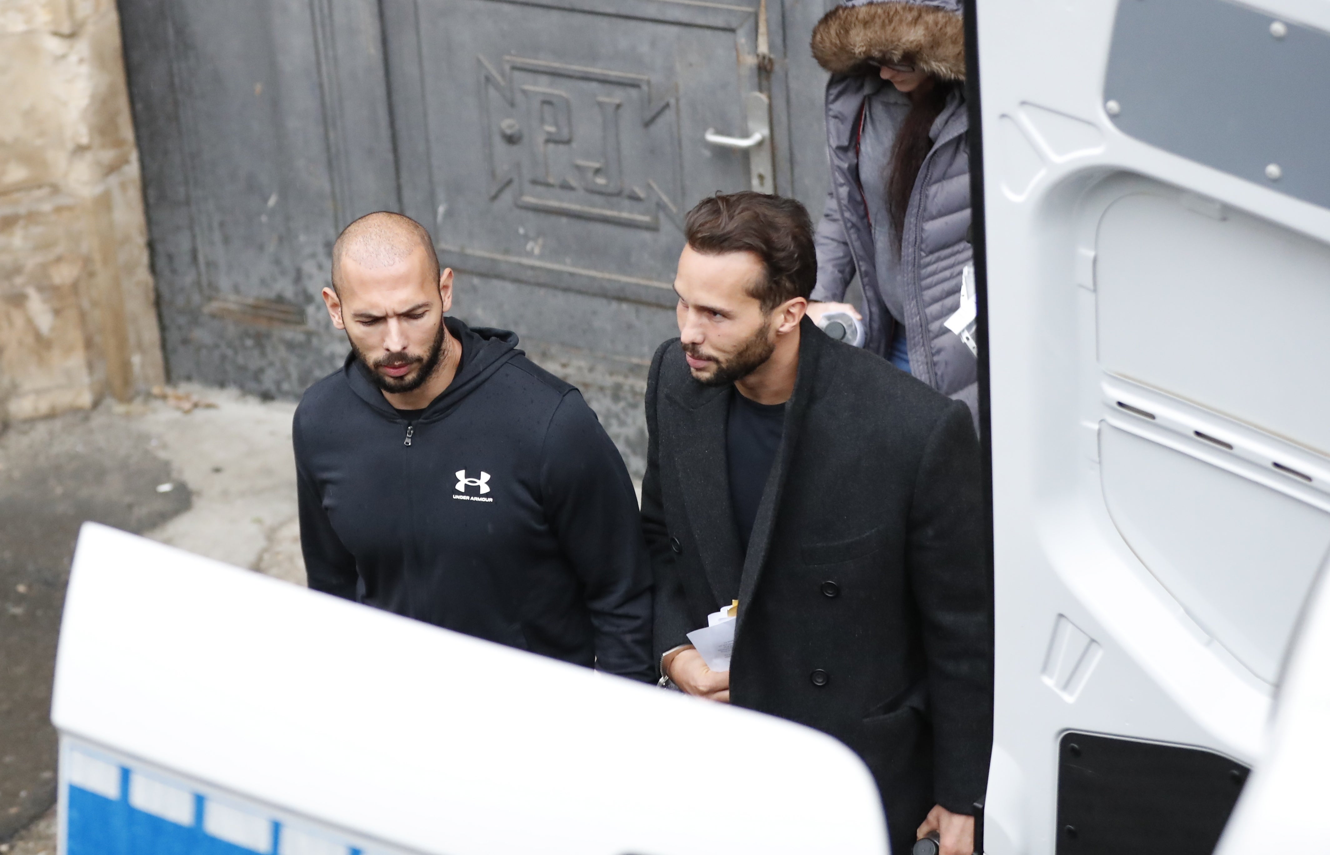 Andrew, right, and Tristan Tate leave court after appeal hearing on Tuesday