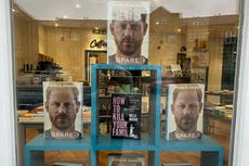‘Spare’ by Prince Harry displayed next to ‘How To Kill Your Family’ in bookstore window