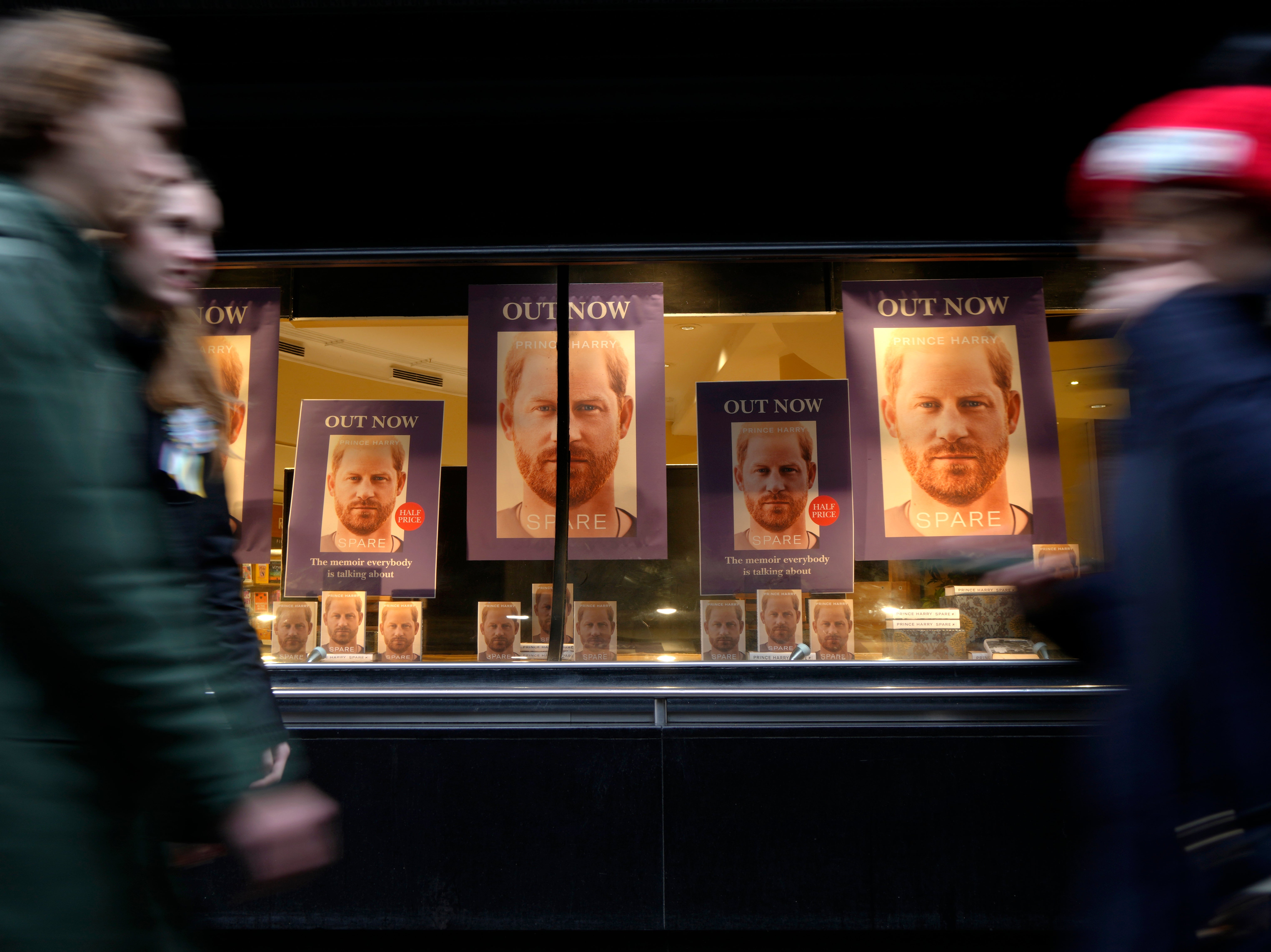 Pedestrians pass a display in the window of a book shop in London (AP Photo/Kirsty Wigglesworth)