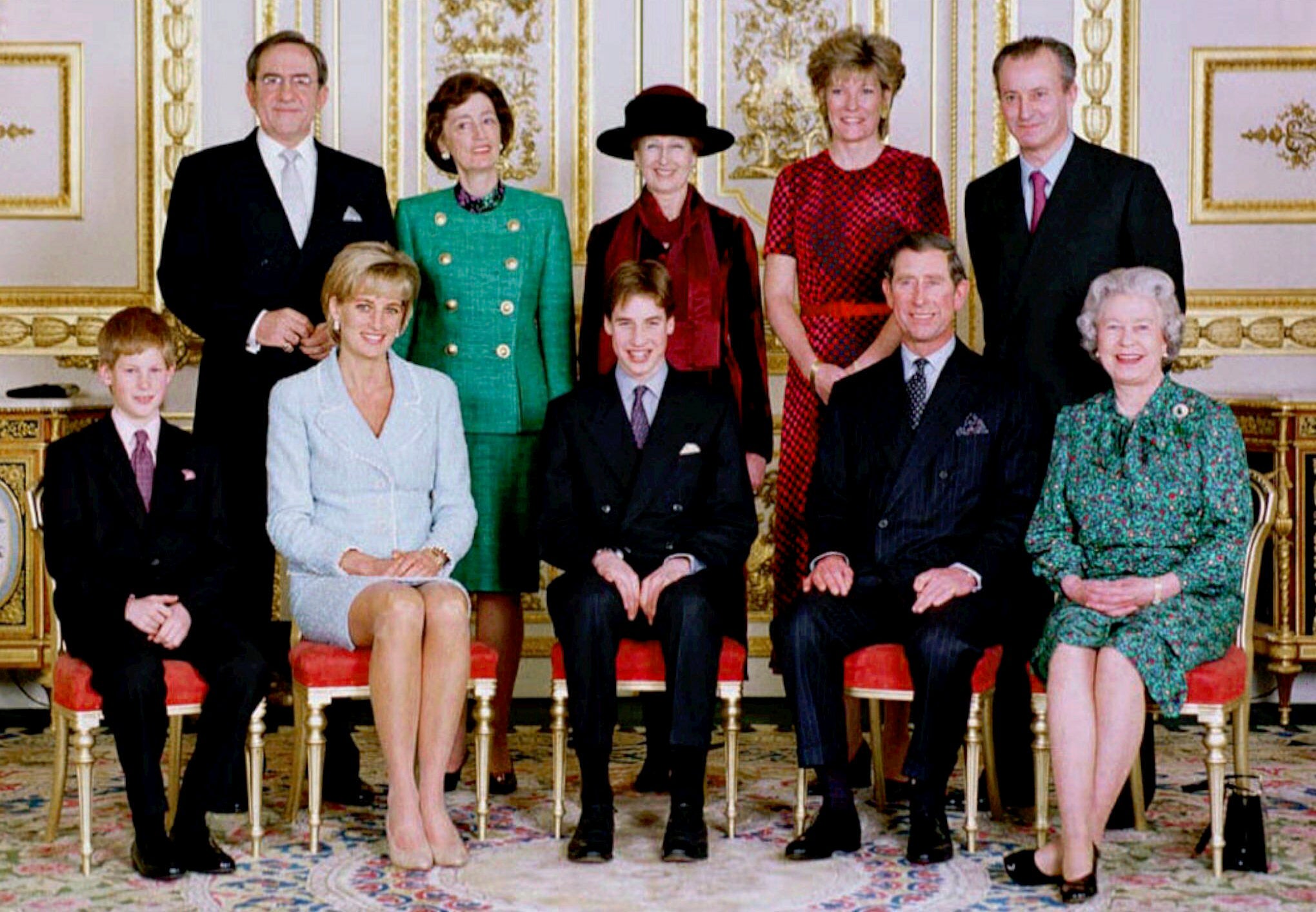 The British royal family pose in the White drawing room of Windsor Castle, Windsor, England. Former King Constantine II of Greece stands in the back row, between the shoulders of Prince Harry and Princess Diana