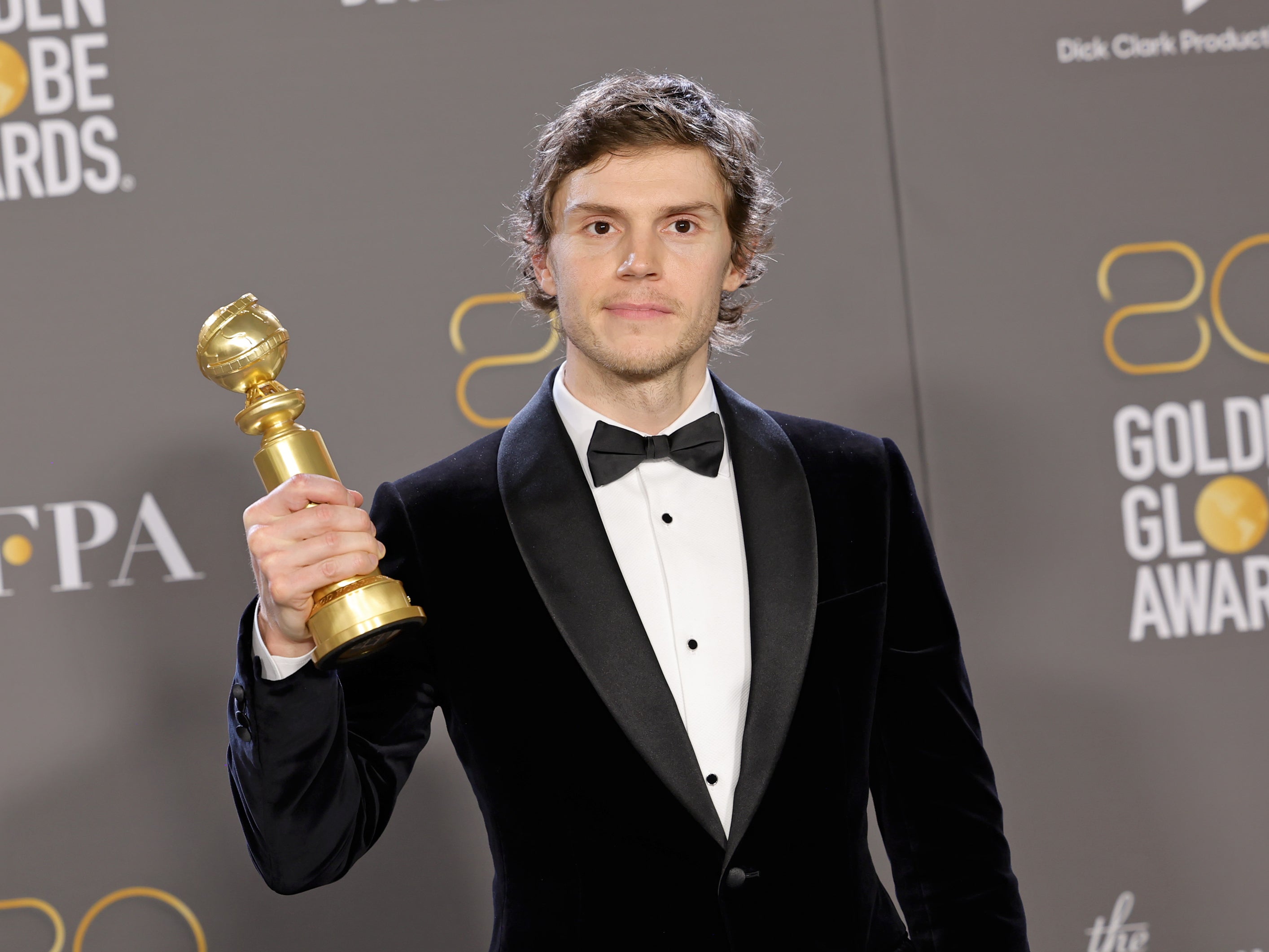 Evan Peters with his Golden Globe trophy