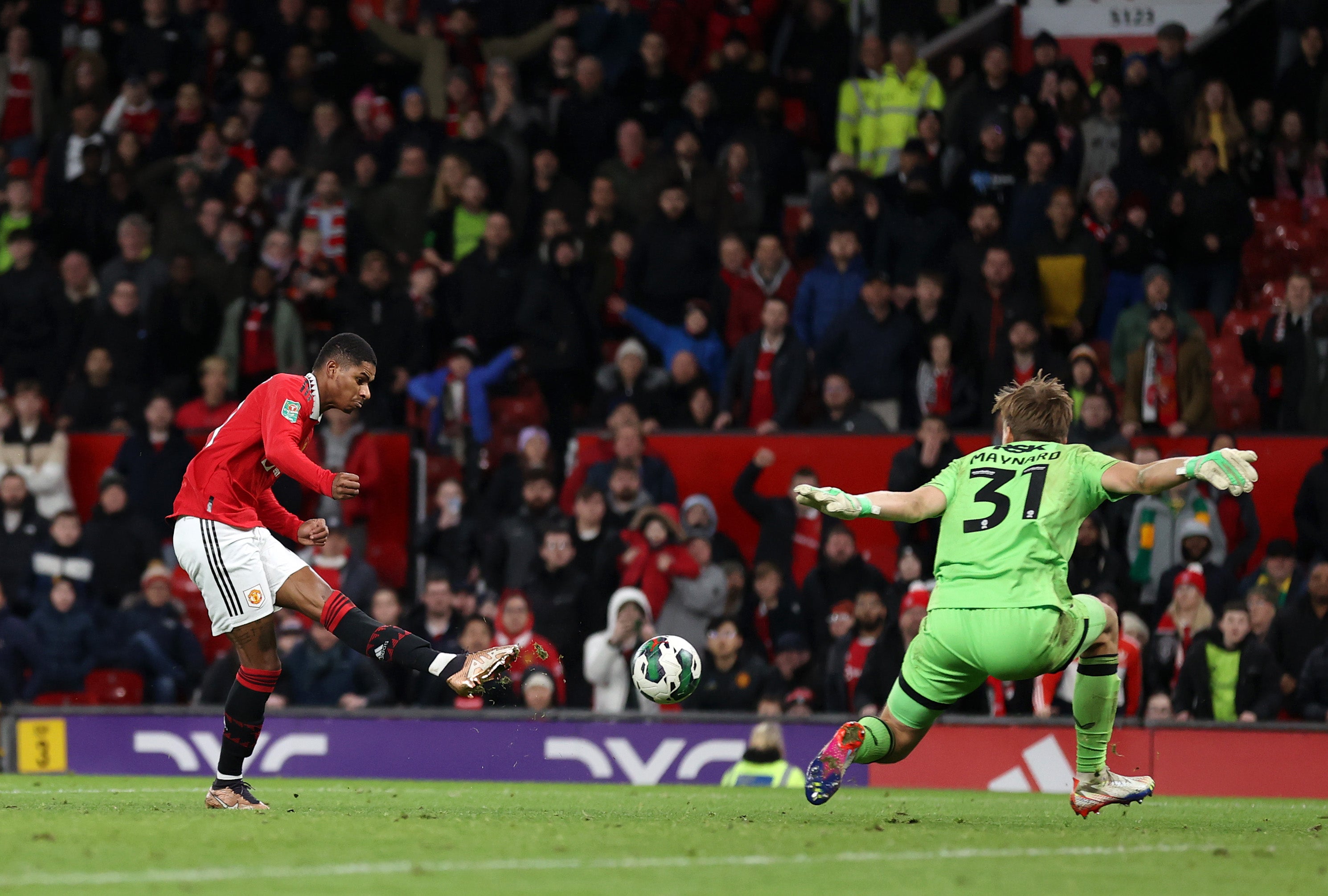 Marcus Rashford shoots past Ashley Maynard-Brewer