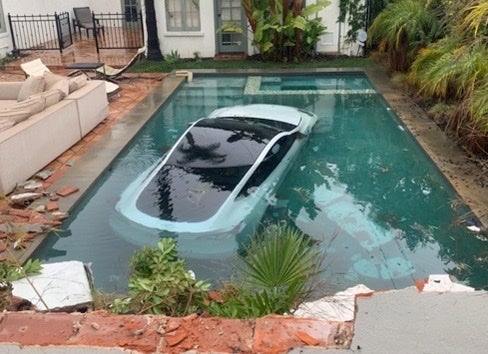 Photo shared by Pasadena Fire Department shows the Tesla submerged in the pool