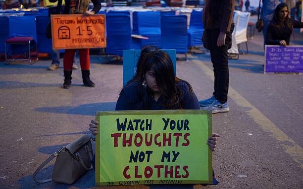 Indian protestors hold placards during a protest over women safety in India in 2014