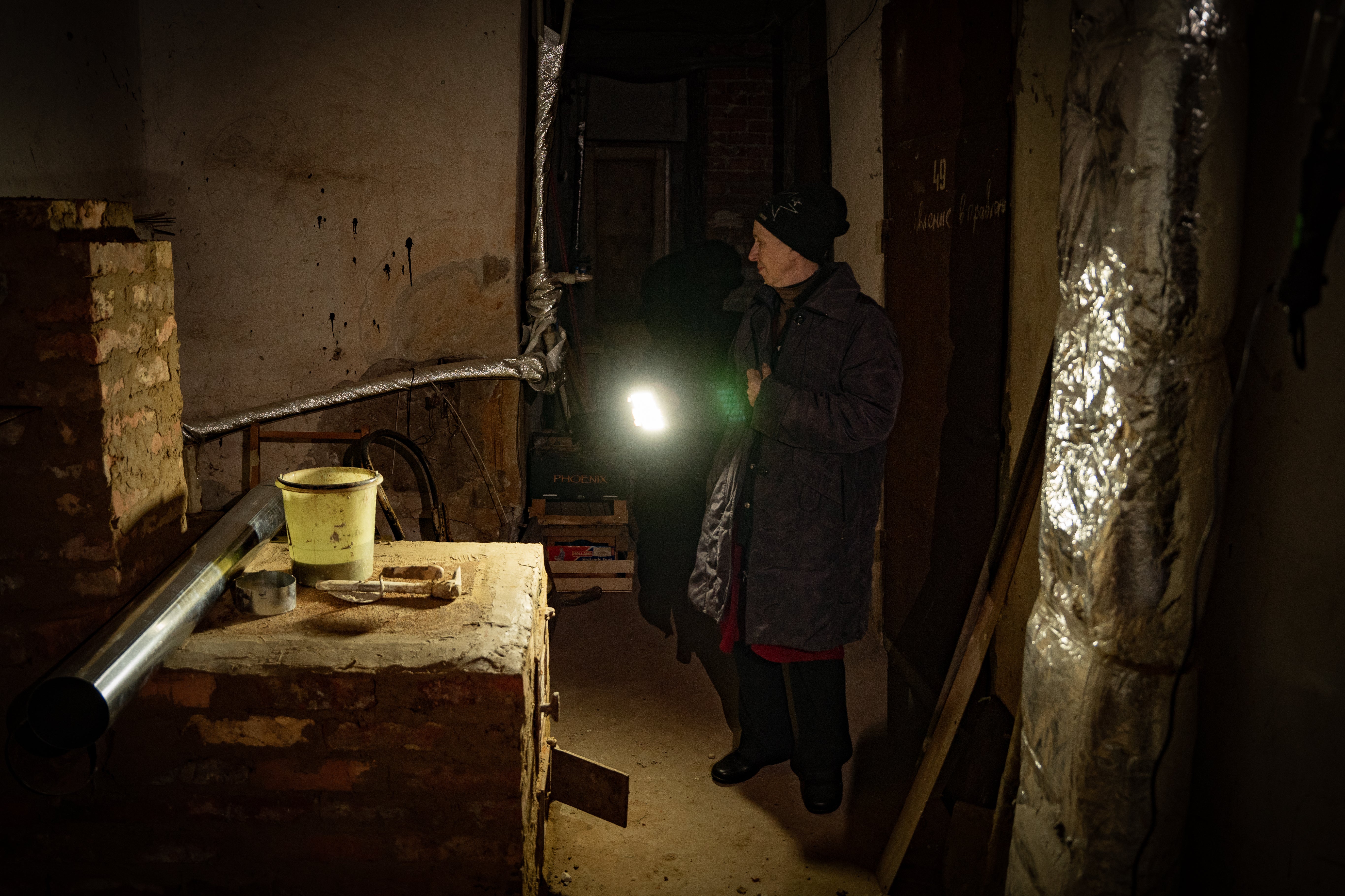 Tamara shows where she has built a stove underground under heavy shelling in Bakhmut