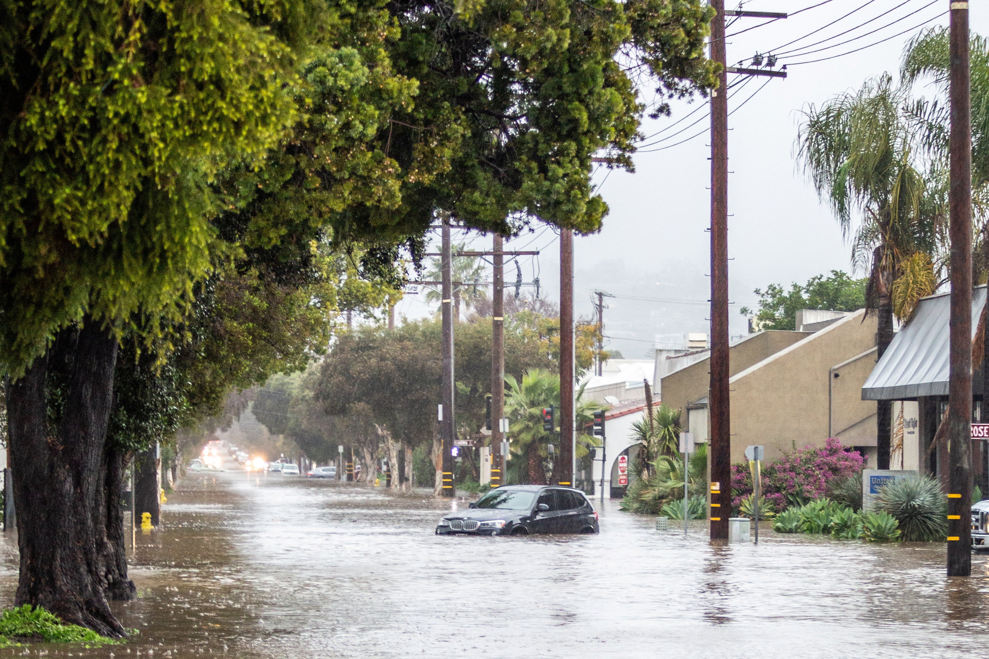 Abandoned cars are left in a flooded street in Santa Barbara earlier this week