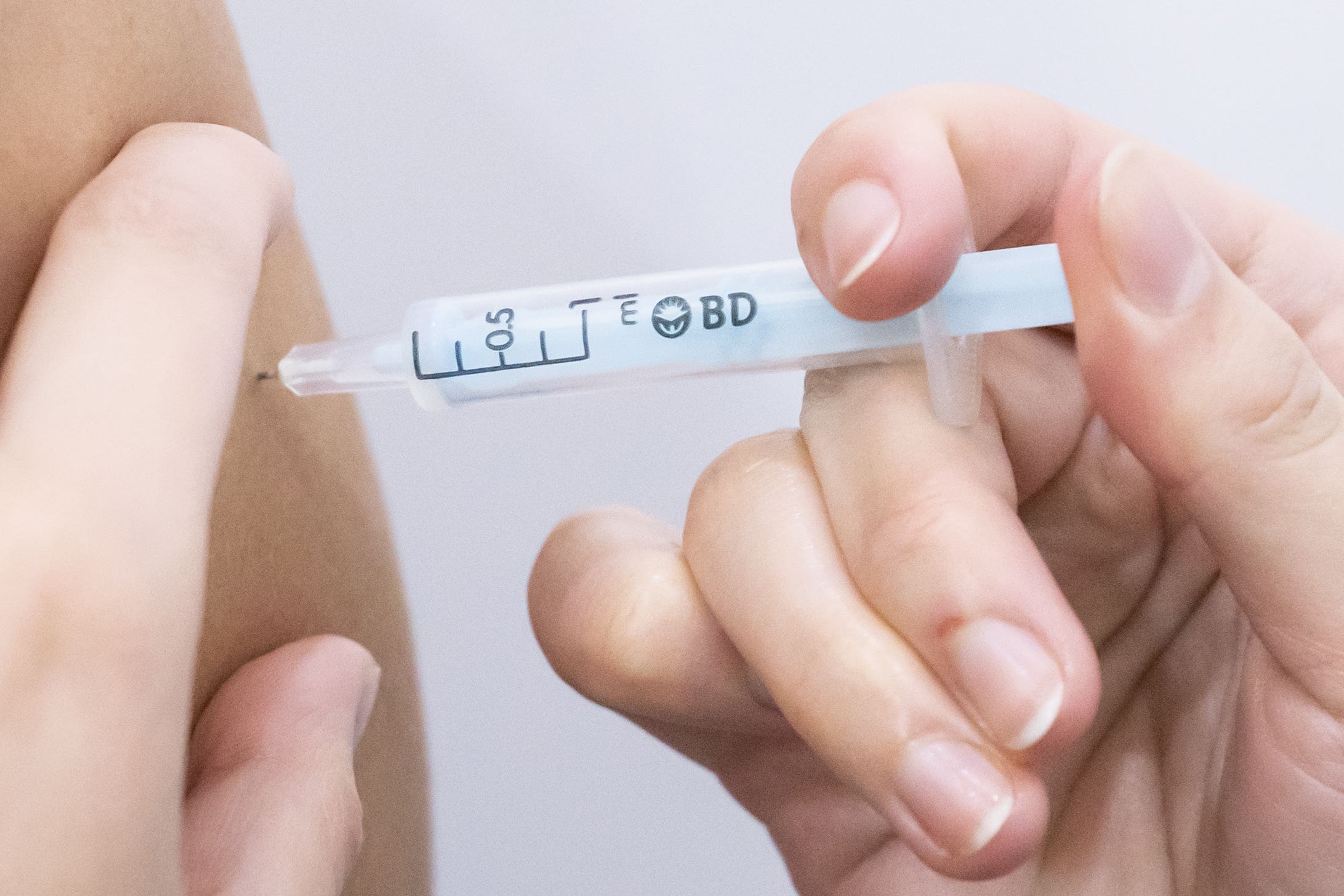 A booster coronavirus vaccine is administered (Danny Lawson/PA)