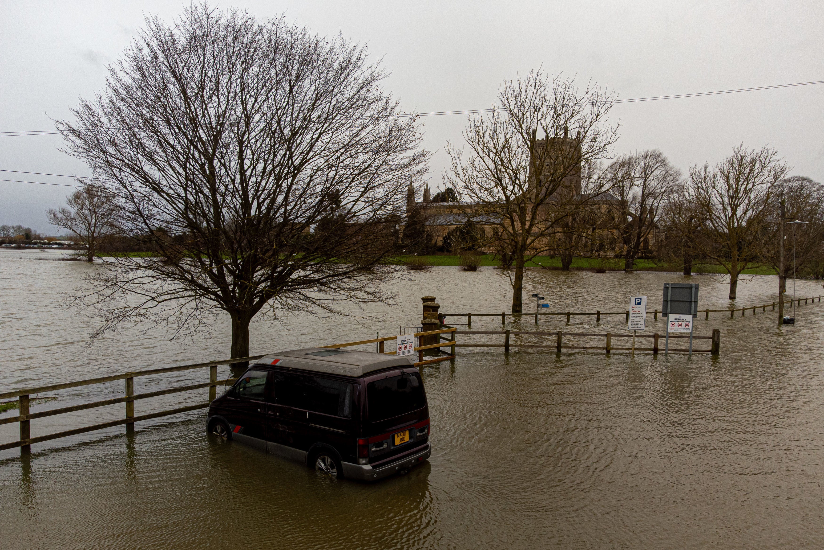 A vehicle in flood waters around Tewkesbury Abbey