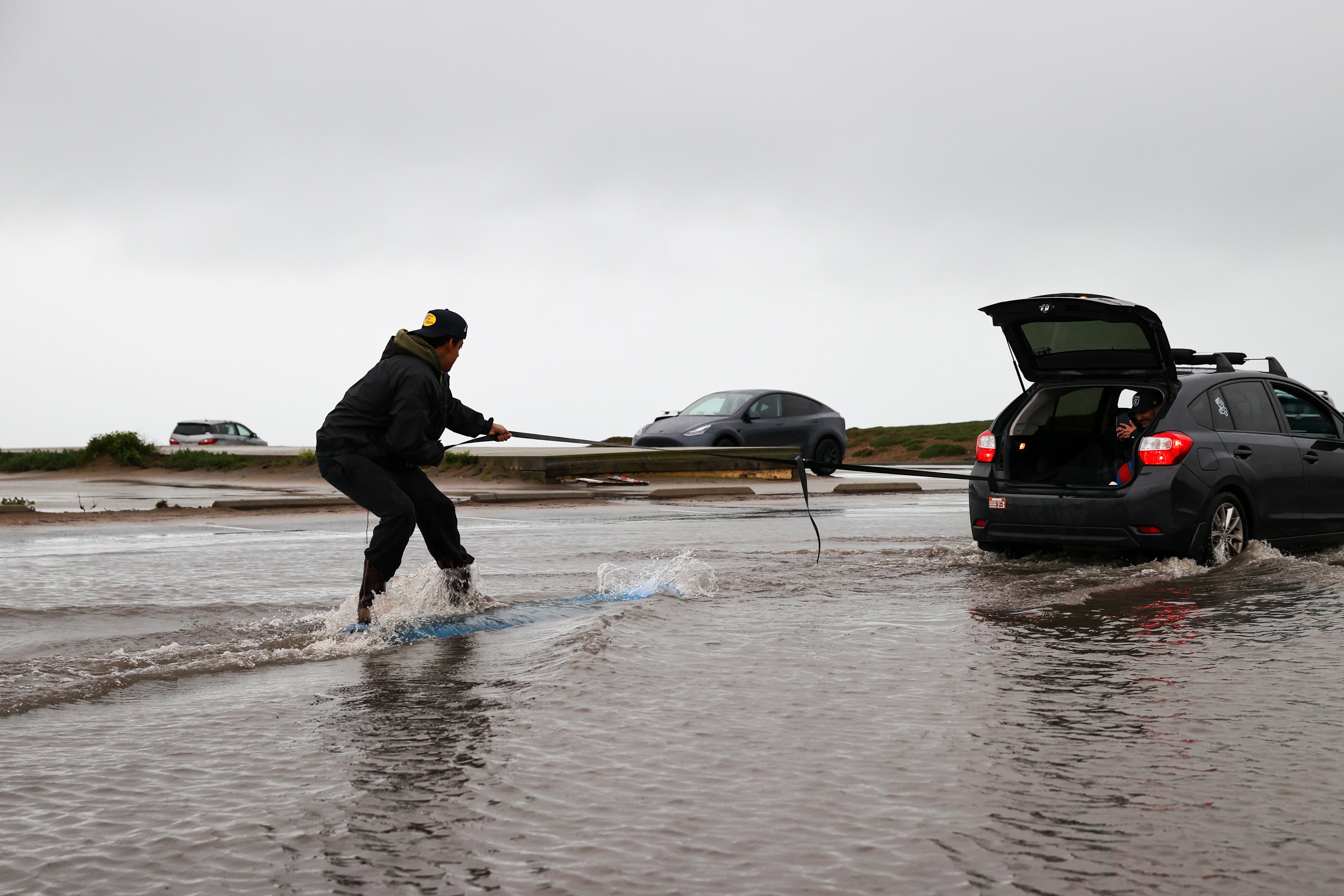 Christian Ibarra surfs in a flood at Fort Funston in San Francisco