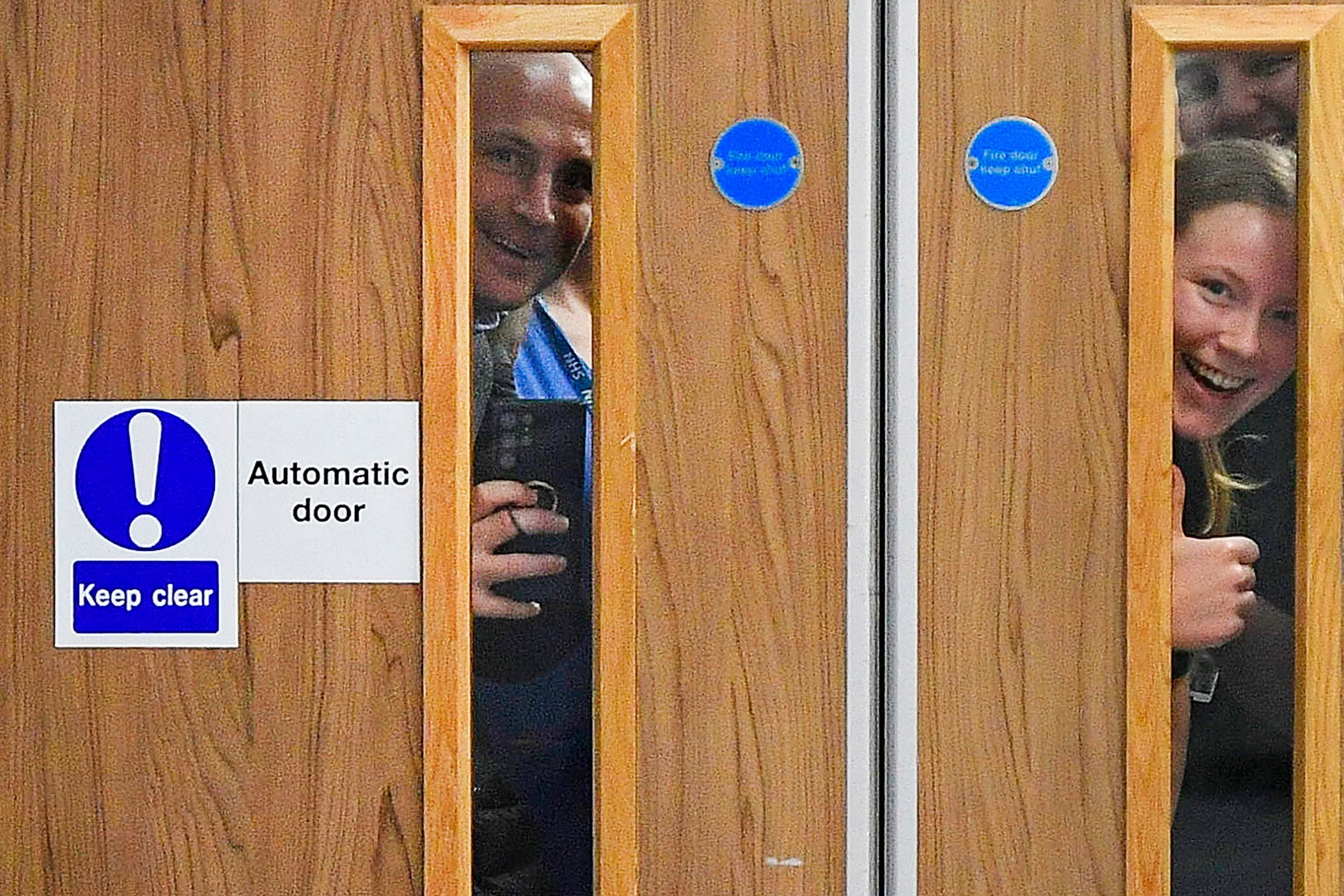 Royal Liverpool University Hospital staff try and get a glimpse of William and Kate during their visit