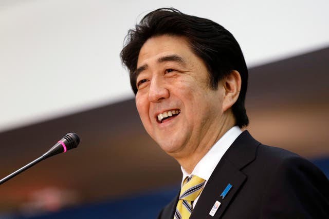 <p>Then-Japanese prime minister Shinzo Abe laughs while speaking at the Center for Strategic International Studies in Washington in 2013</p>