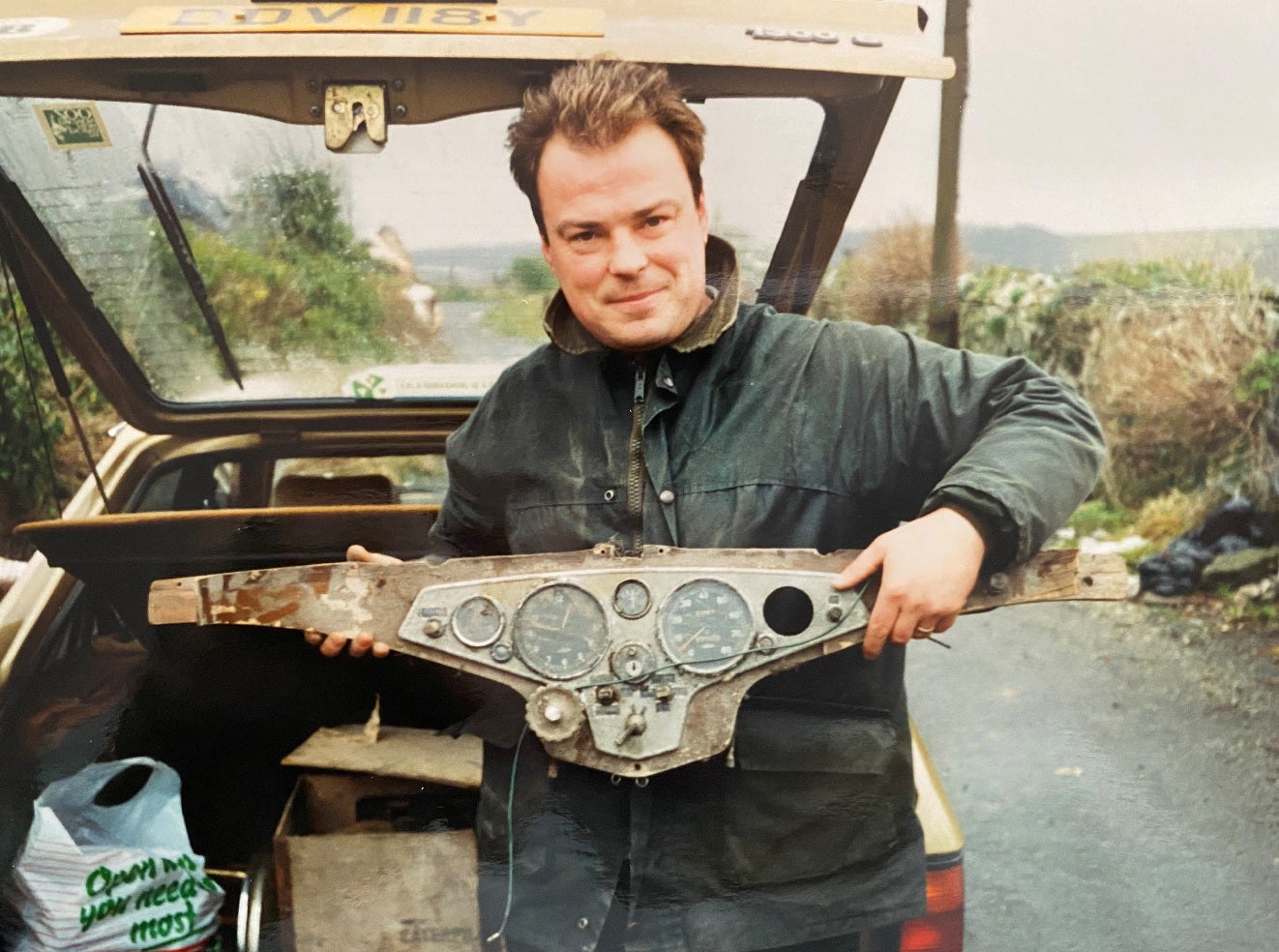 Mr Crawford holds part of a motorcycle in an old family photo