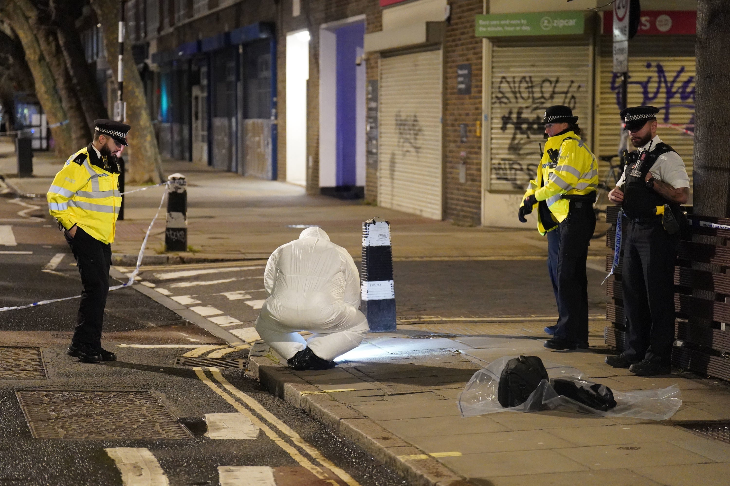 A police forensics officer works near the scene on Phoenix Road