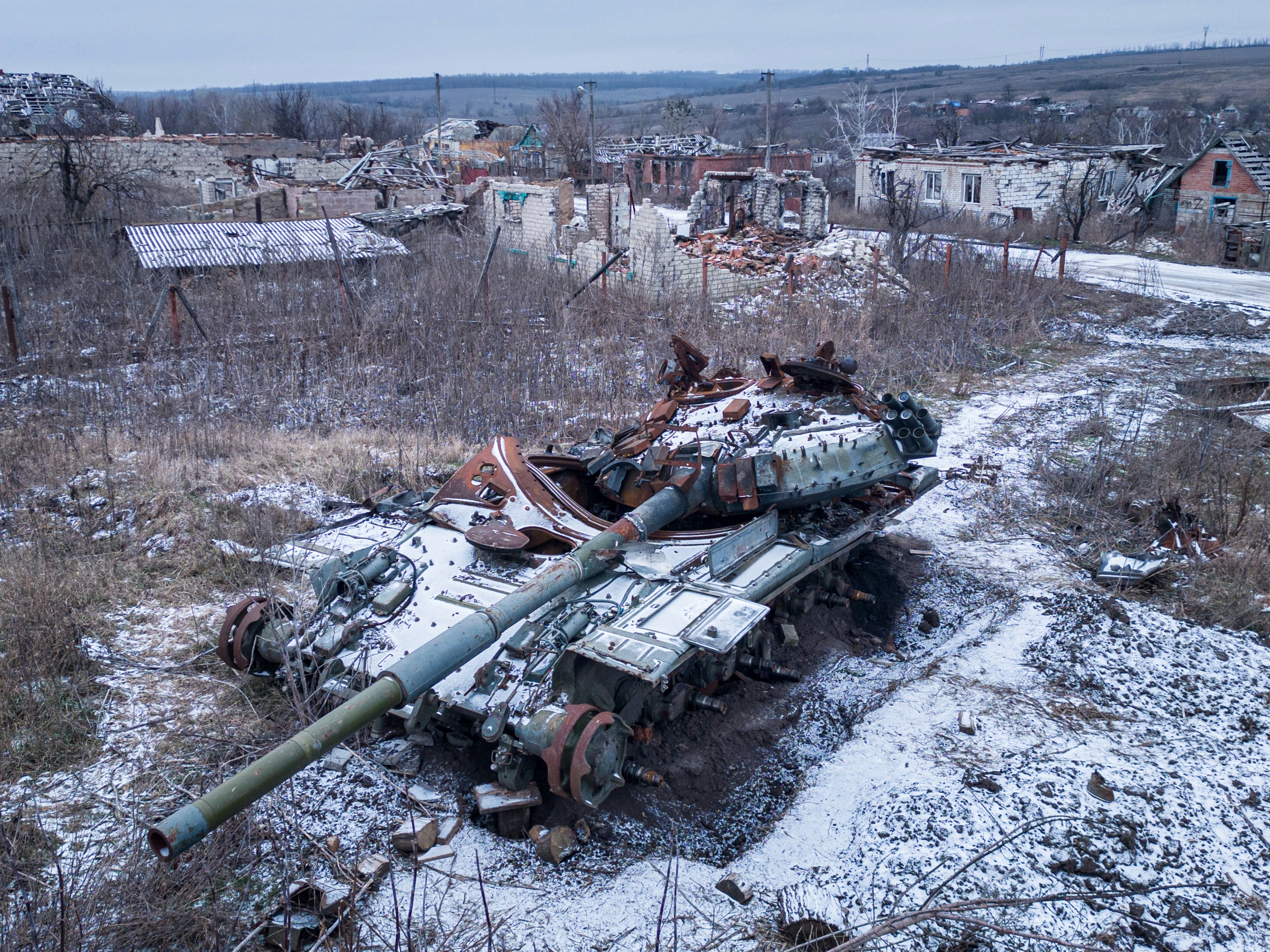 A destroyed Russian tank covered by snow stands in the village of Kamyanka, Kharkiv