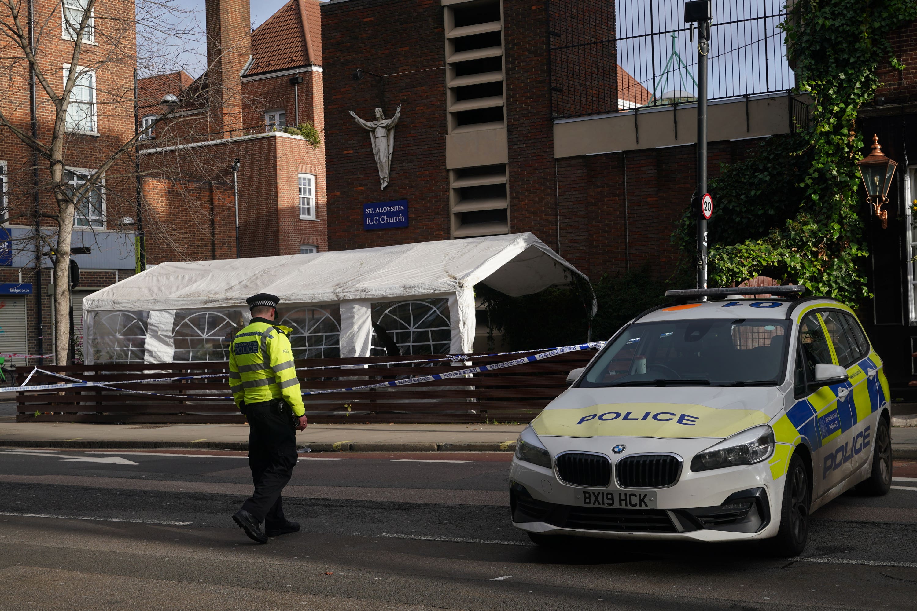 The scene of a shotgun attack remains cordoned off on Sunday as officers investigate (Yui Mok/PA)