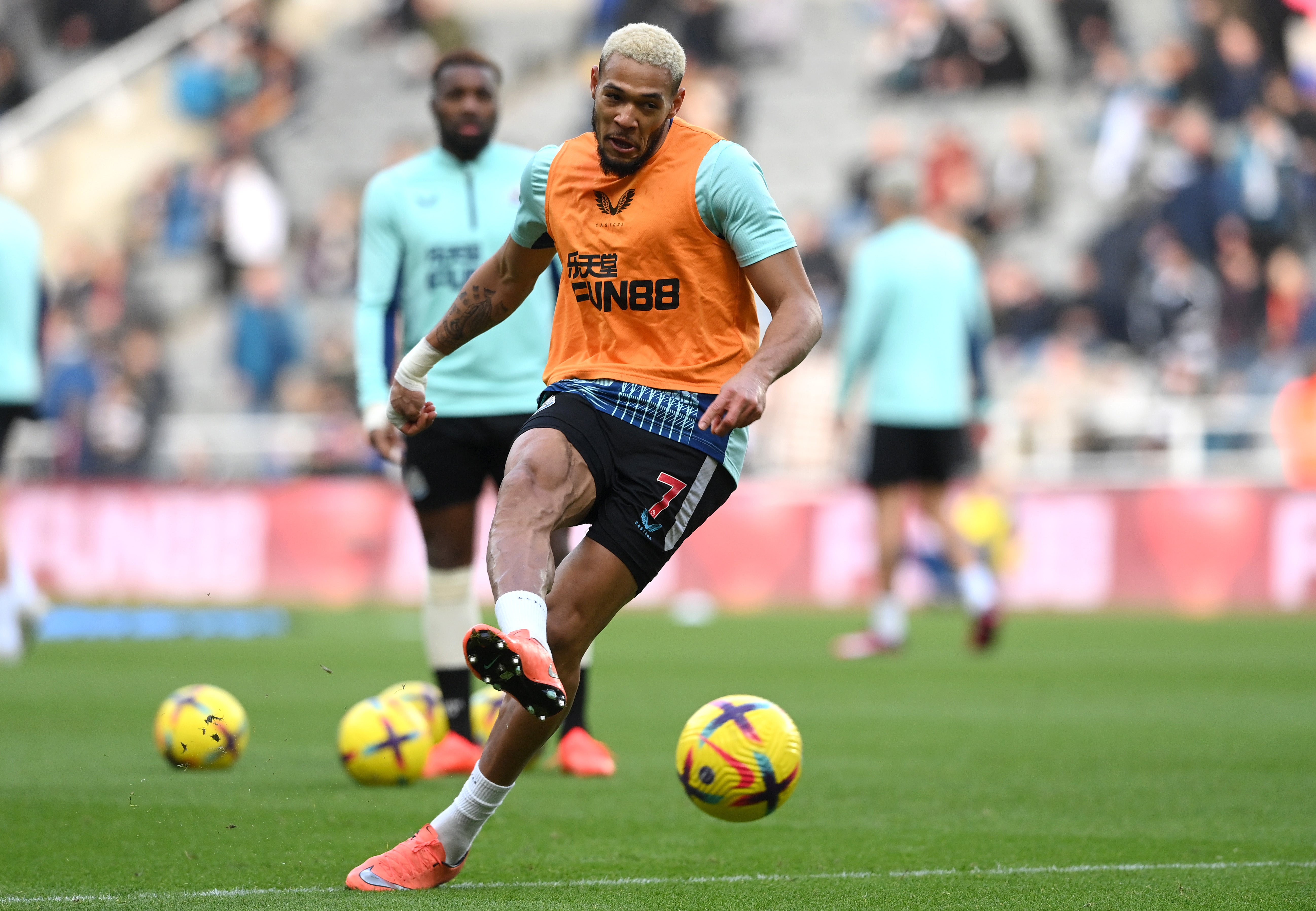 Joelinton warms up before kick-off at St James’ Park