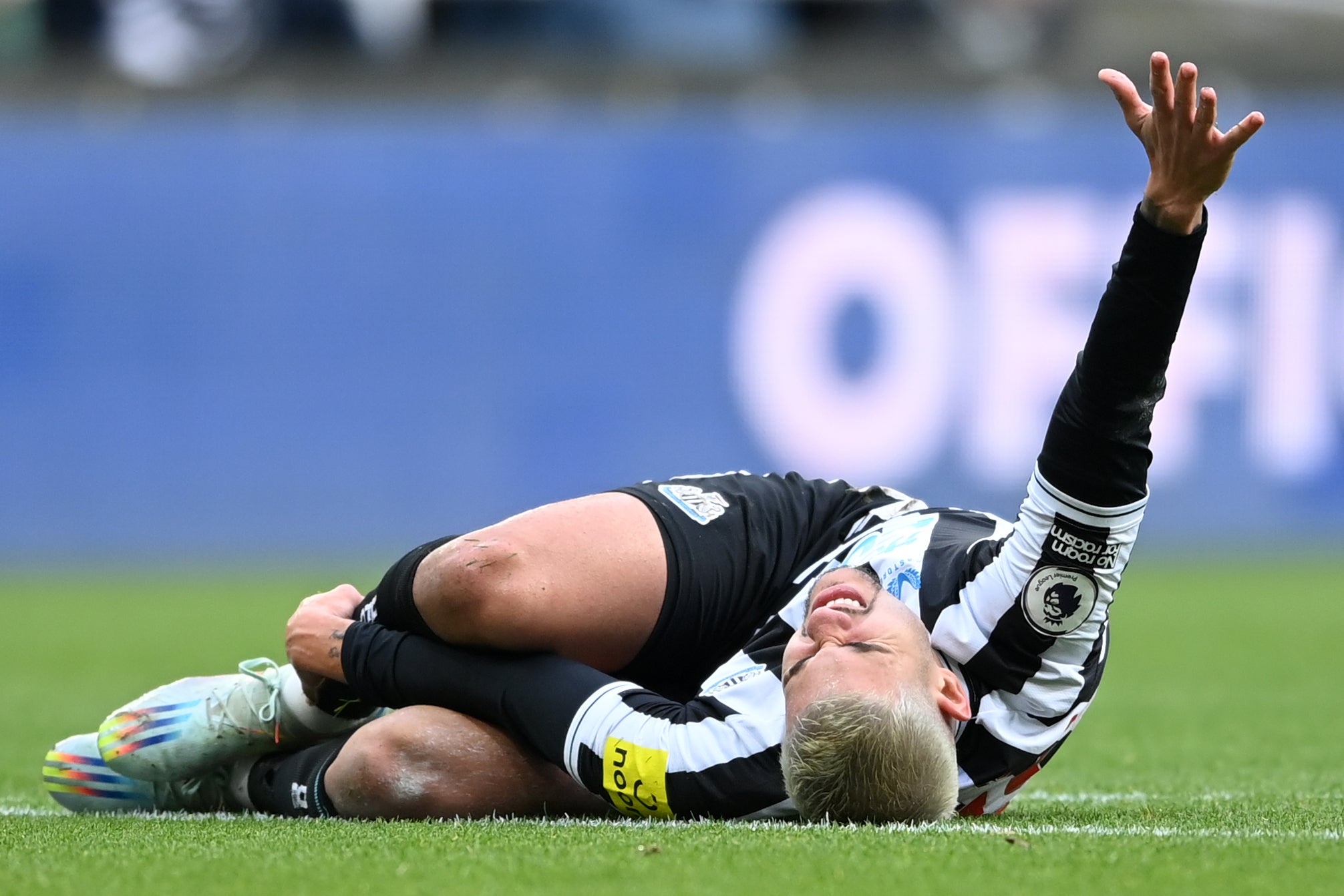 Bruno Guimaraes gestures to the touchline after injuring his ankle