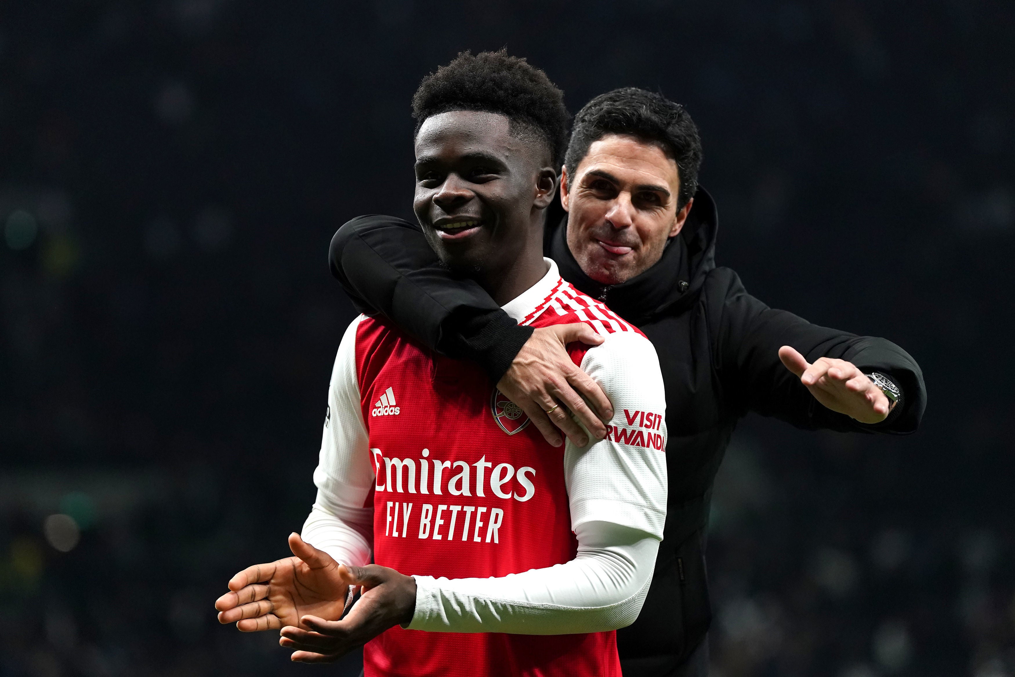 Arsenal’s Bukayo Saka celebrates with manager Mikel Arteta