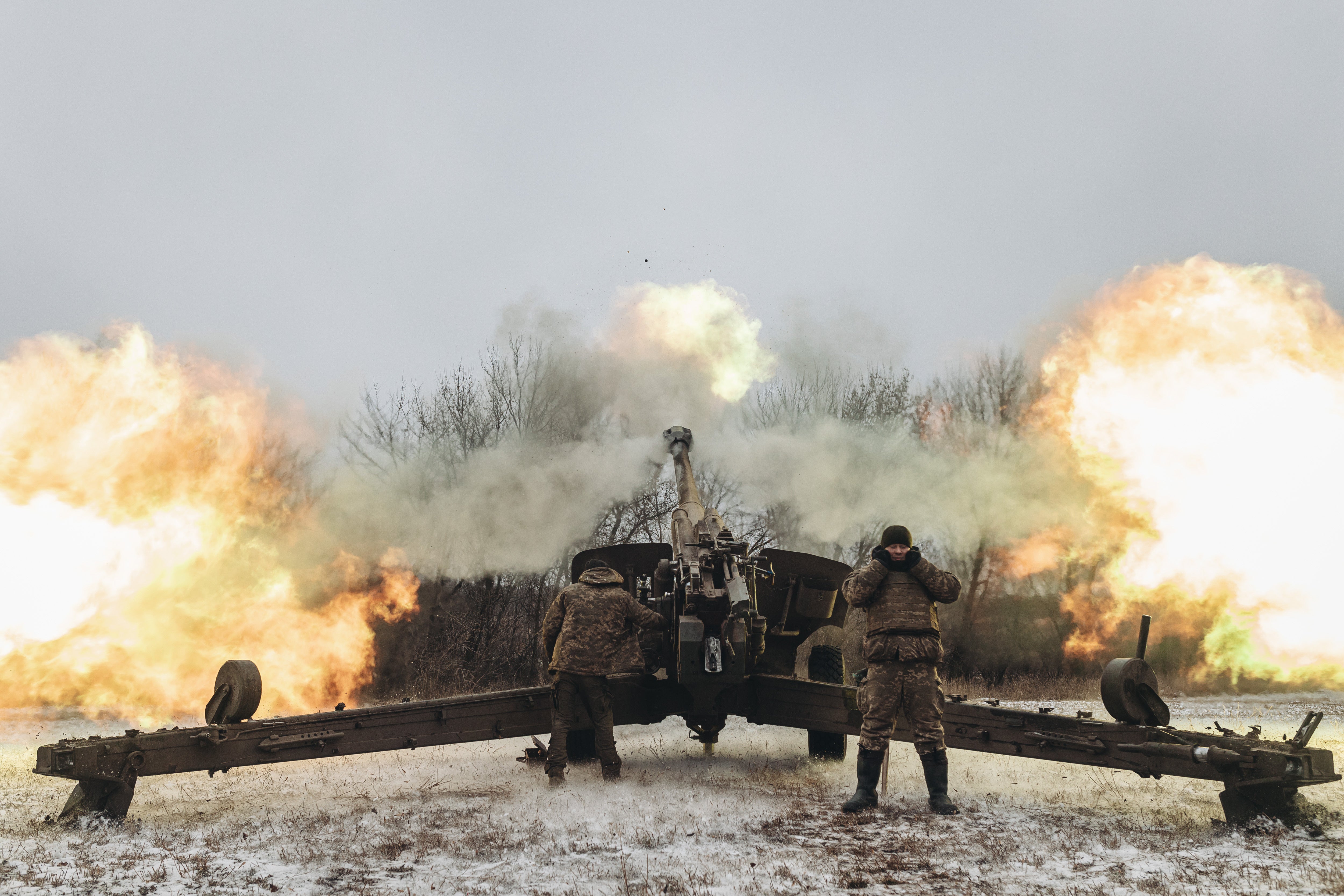 Ukrainian soldiers work in their artillery unit in the direction of Marinka