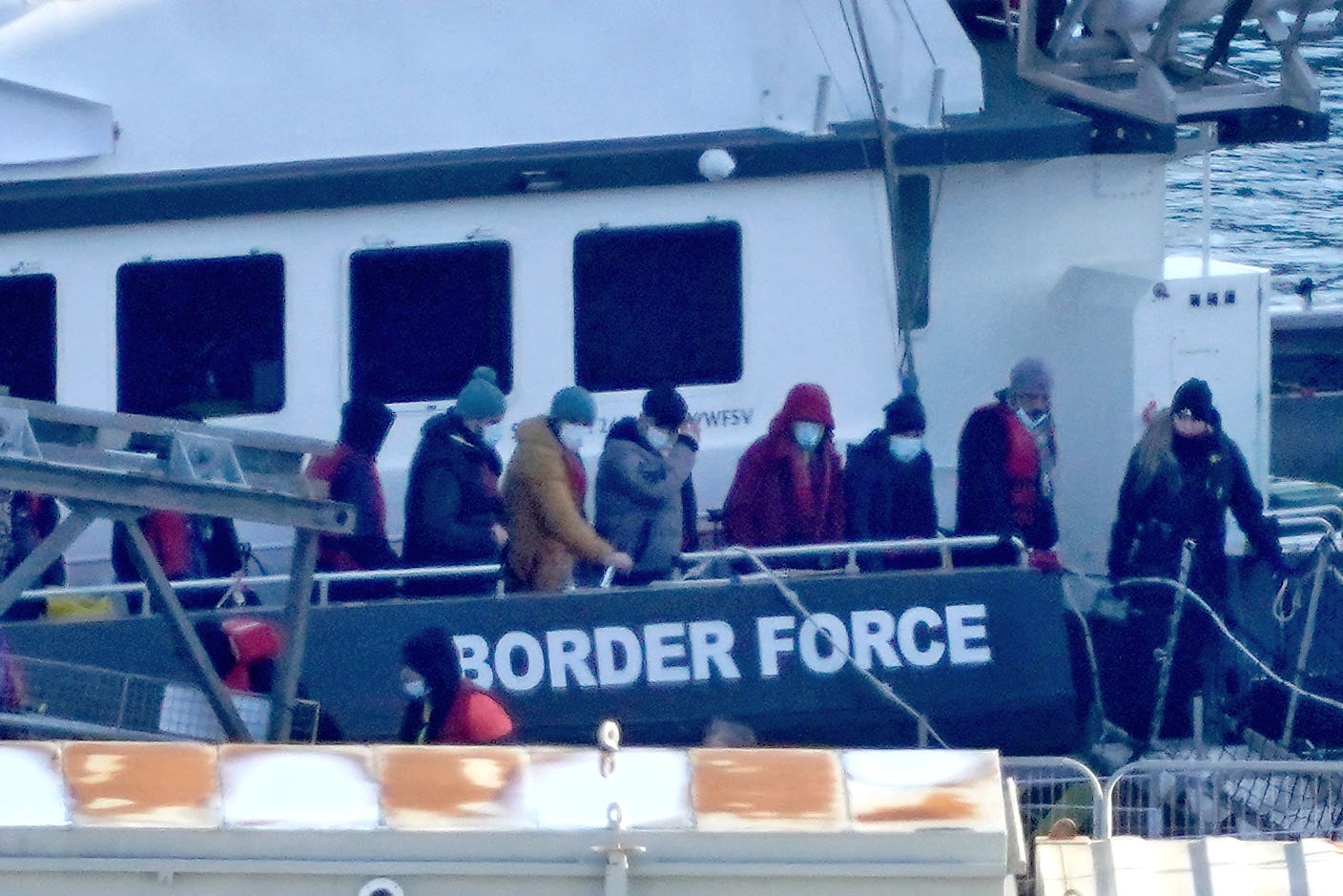 A group of people thought to be migrants are brought in to Dover (PA)