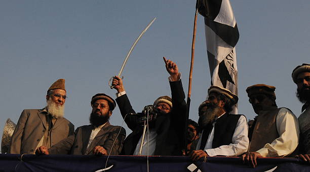 Abdul Rehman Makki addressing a Kashmir solidarity day rally in Lahore in 2012 where at least 1,000 people formed a human chain in Pakistan-administered Kashmir