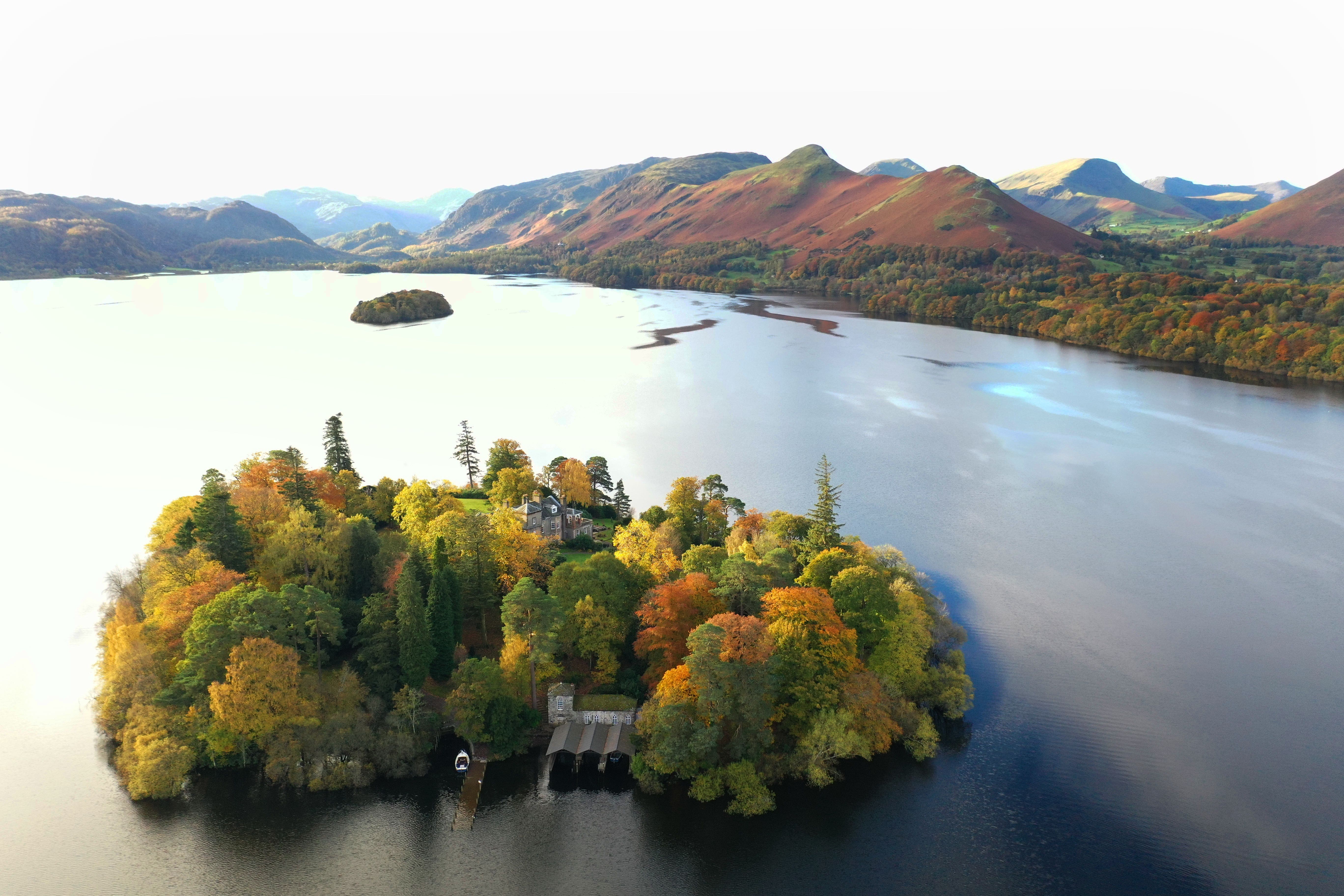 Trees in autumn colours on Derwent island, Derwentwater in the Lake District (Owen Humphreys/PA)