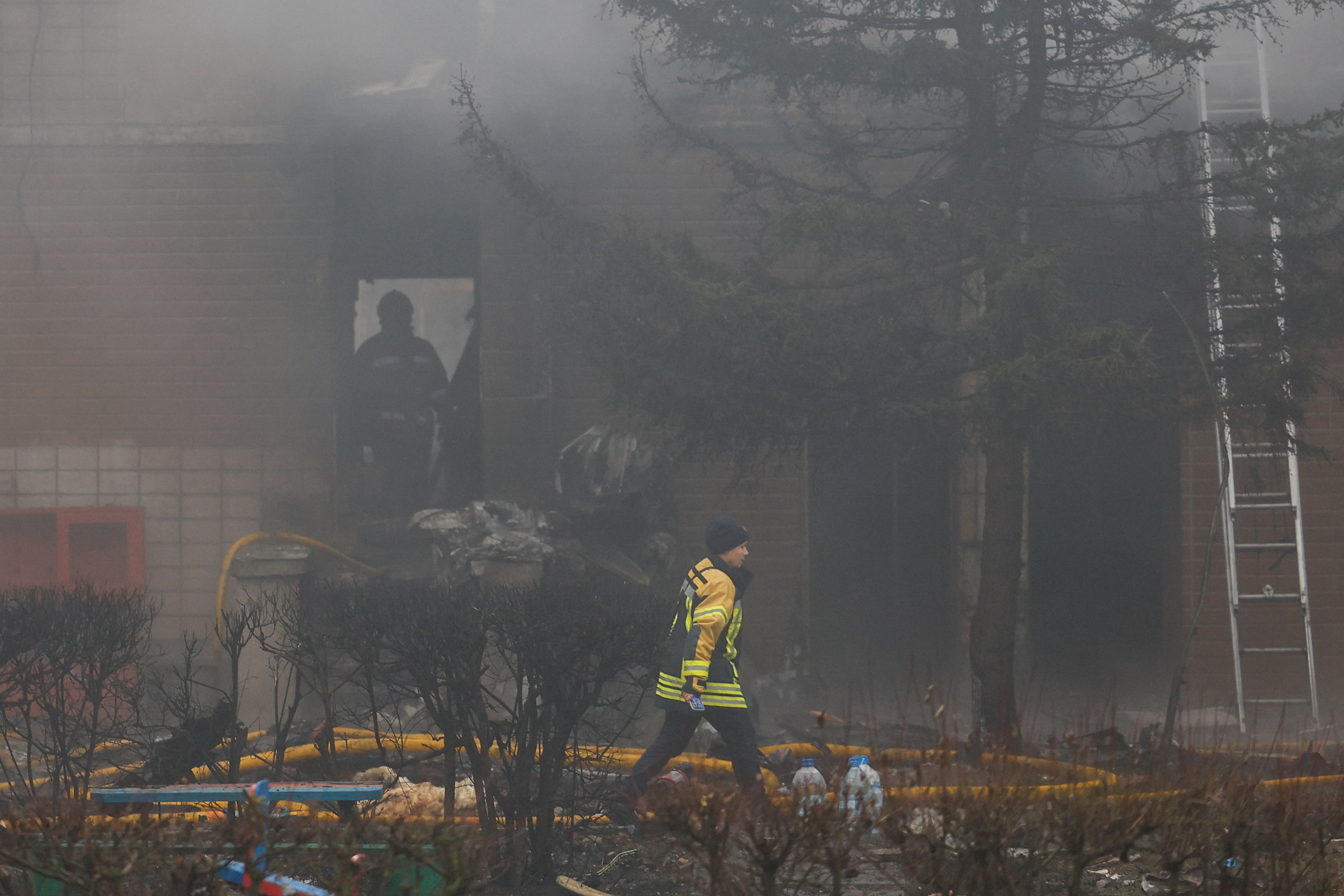 Emergency personnel work at the site of a helicopter crash