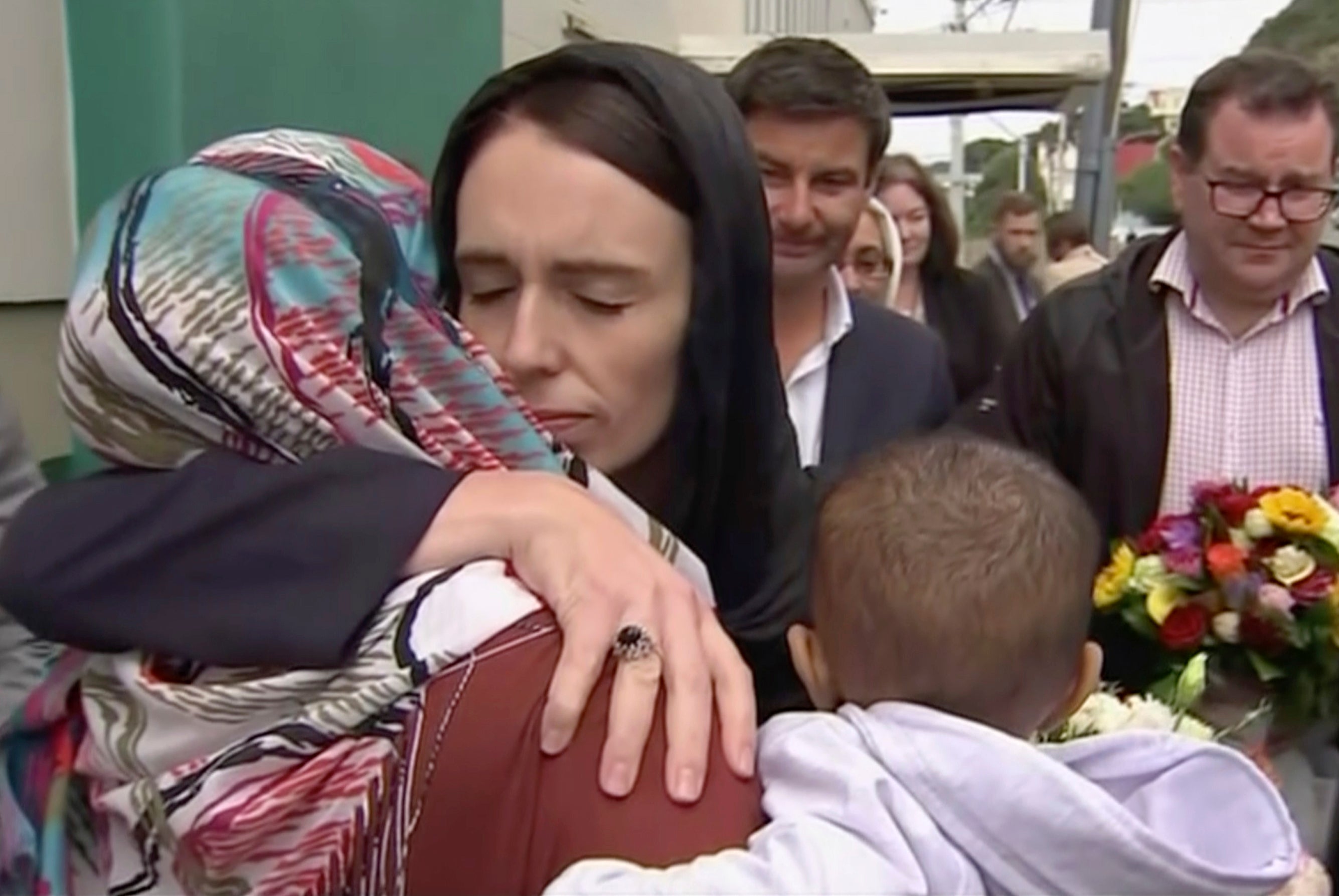 New Zealand's Prime Minister Jacinda Ardern, center, hugs and consoles a woman as she visited Kilbirnie Mosque