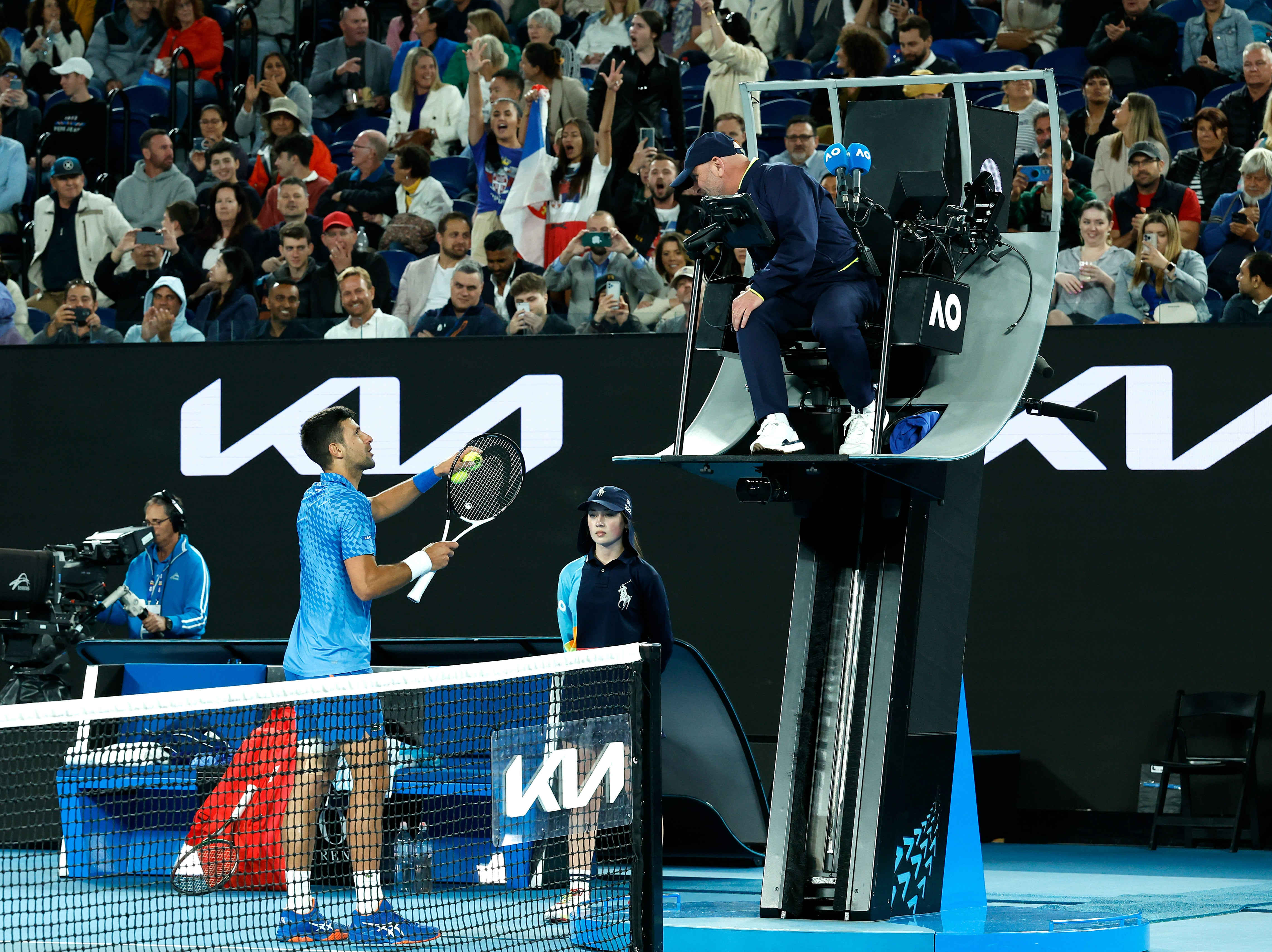 Novak Djokovic of Serbia talks to chair umpire Fergus Murphy