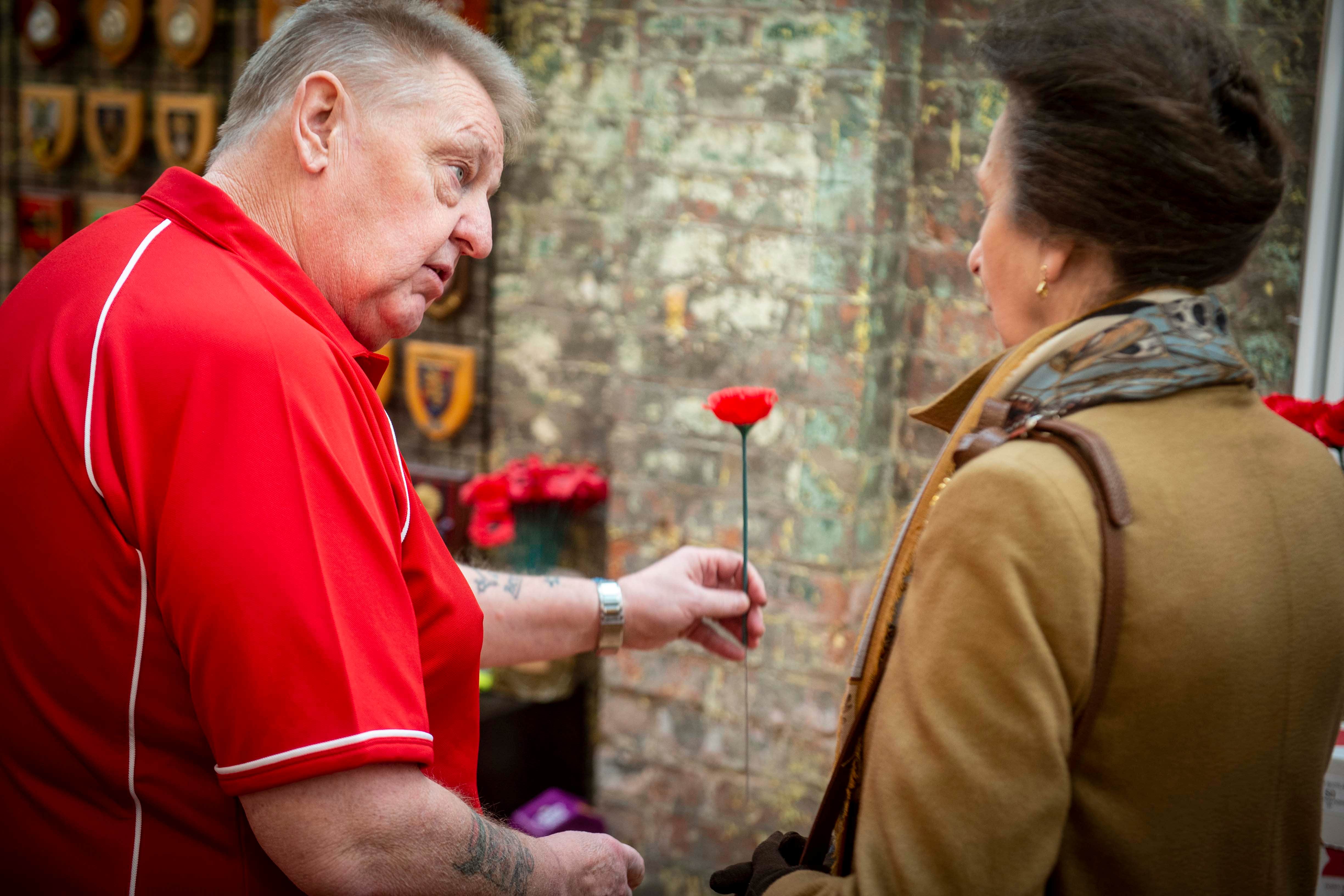 David Adamson presents the Princess Royal with a poppy (Mark Owens/Poppy Scotland/PA)