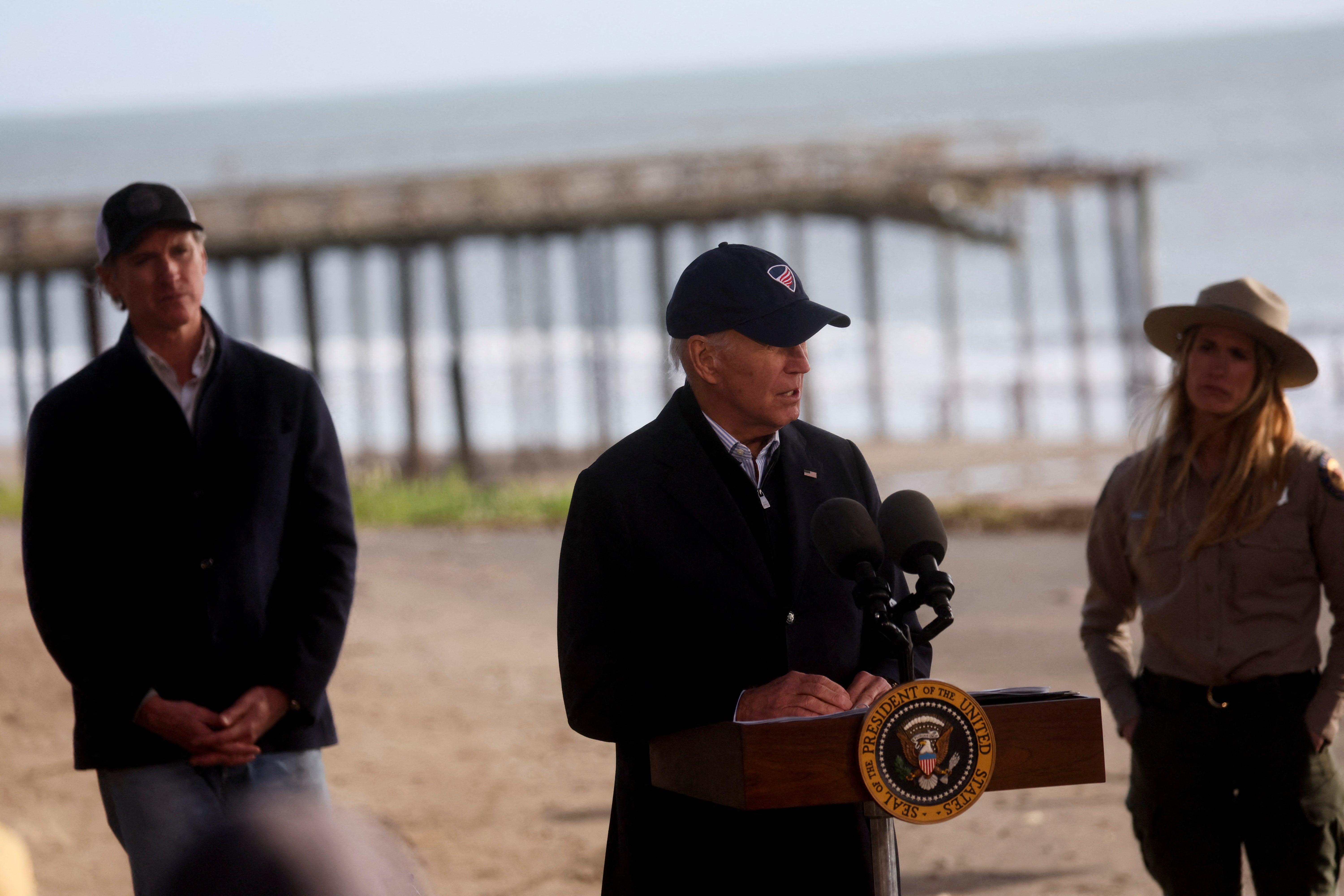 President Joe Biden speaks to the media at Seacliff State Park as California's Governor Gavin Newsom, left, looks on,