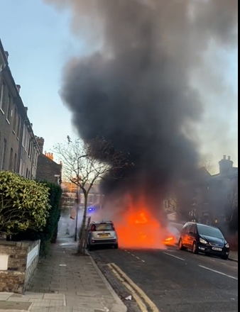 Firefighters attempted to put the fire out as nearby cars were also damaged