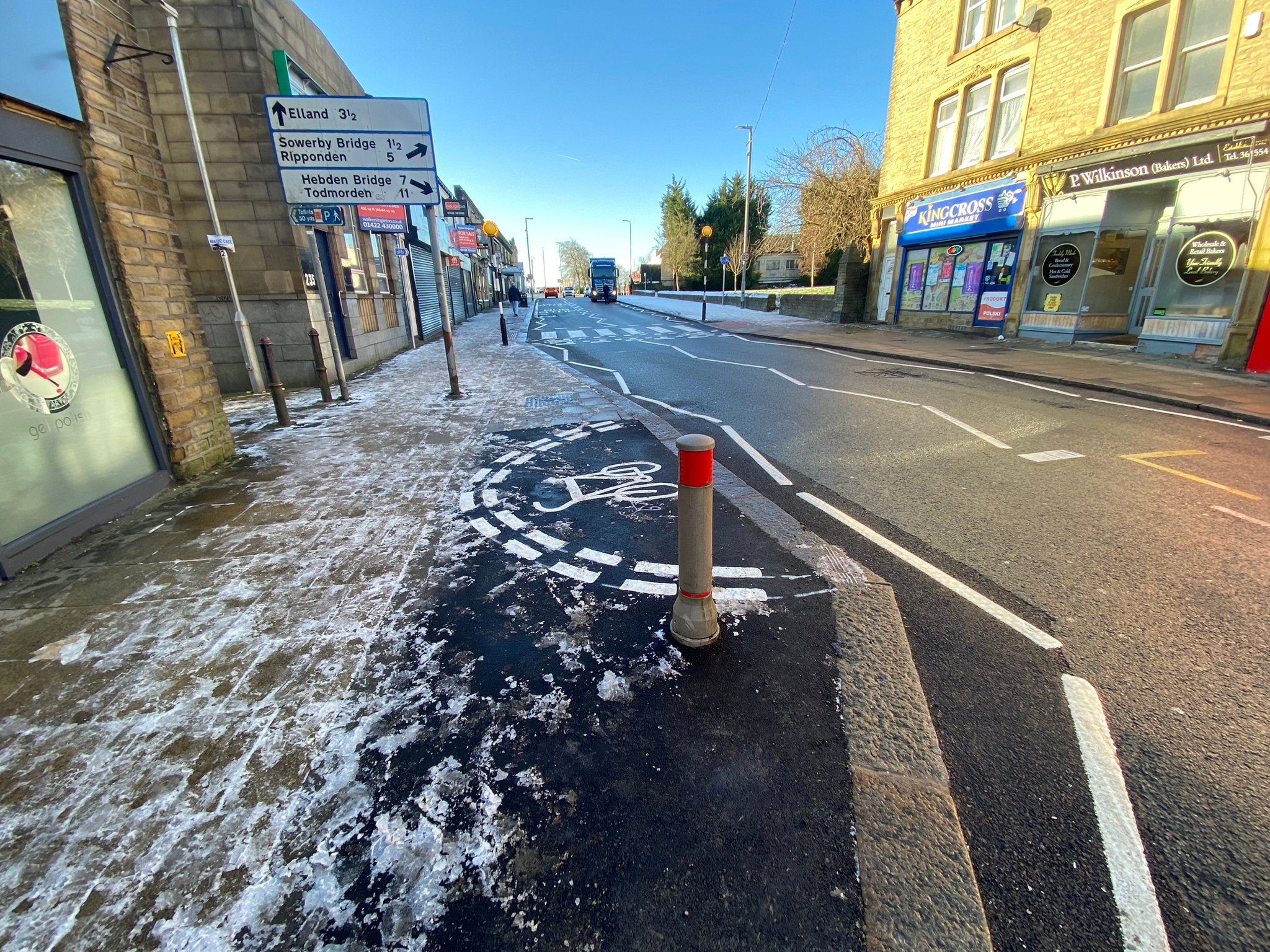 Council chiefs have been blasted for wasting tax payers money after their workers painted a weird semi-circular cycle lane on a towns main road